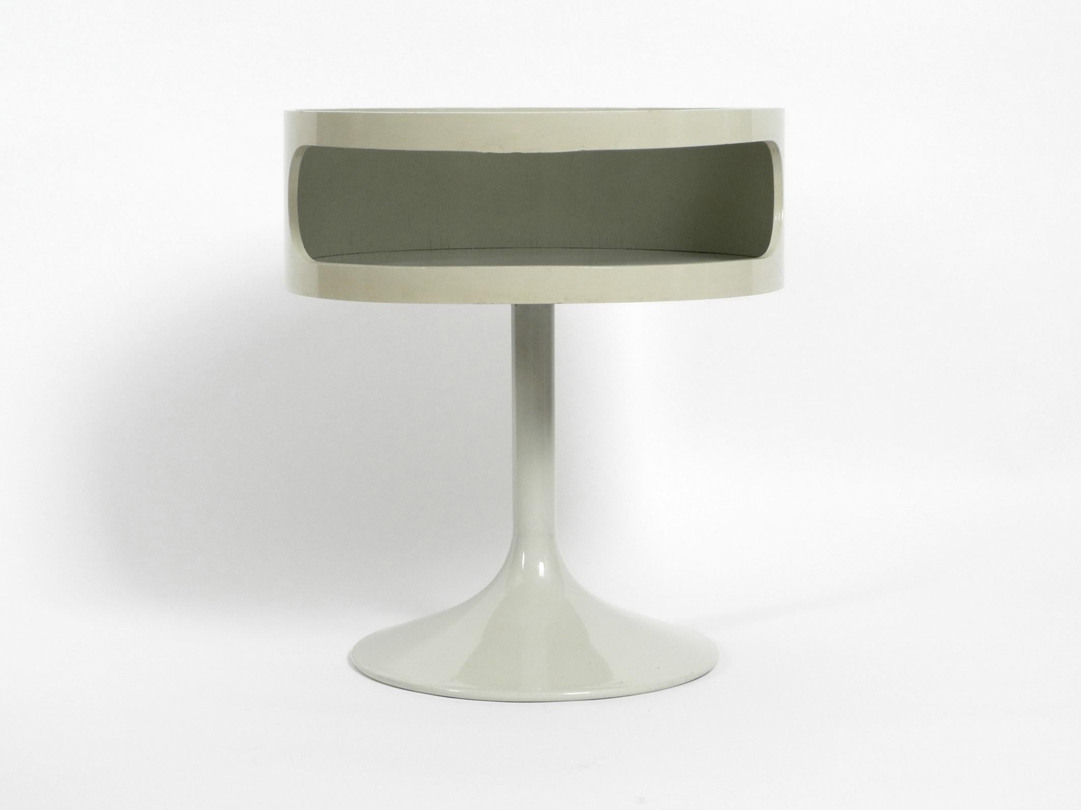 Beautiful rare original 1970s white side table by Opal Möbel.
Stunning Pop Art design with smoked glass plate and tulip base.
Very good vintage condition with very few signs of wear and a nice patina.
Shelf is made of white lacquered wood, neck