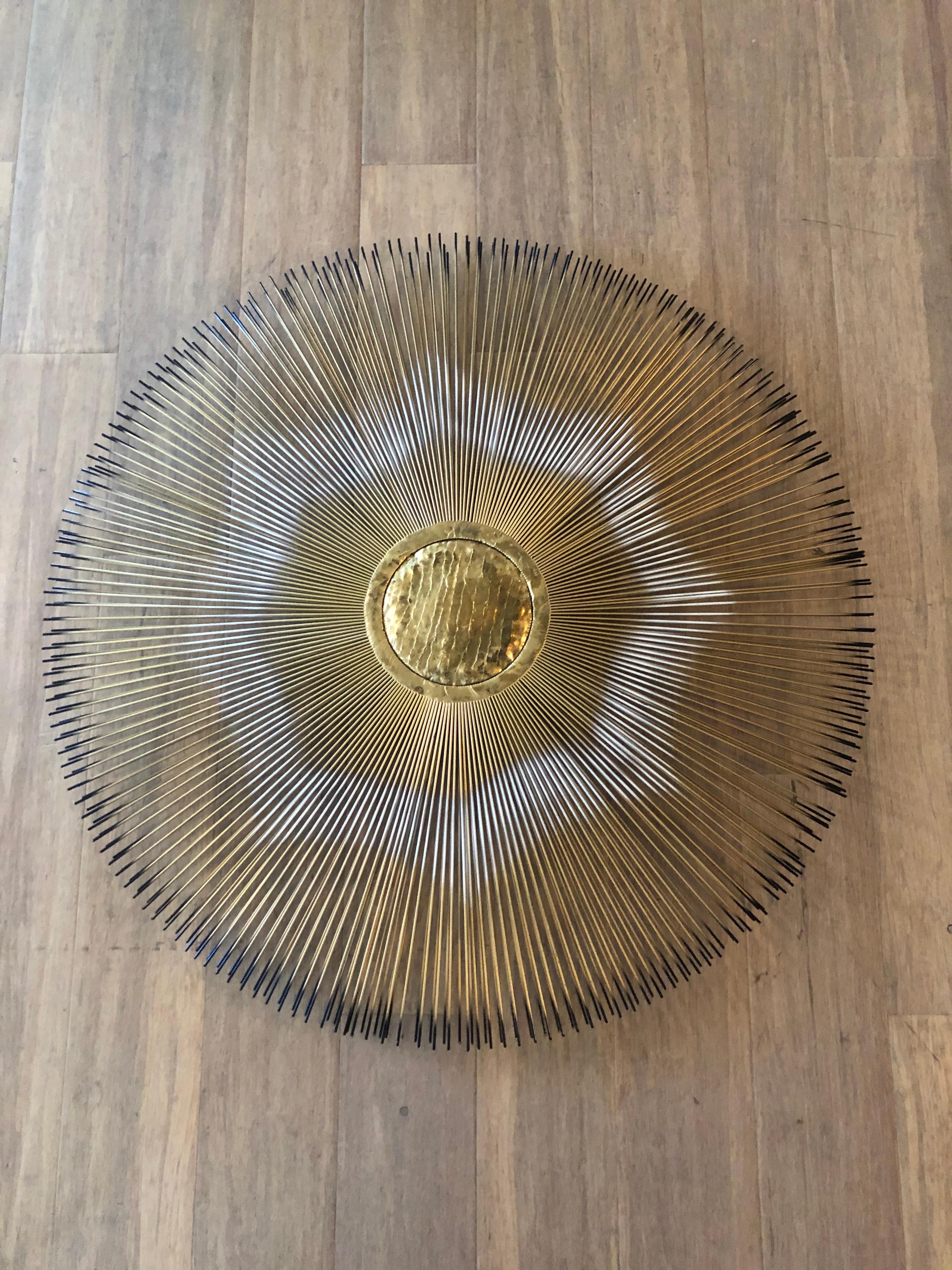 1970's Signed Casa Devall starburst wall sculpture. Quite a Glamourous statement piece . Mixing metals in with artwork is very in style right now. 