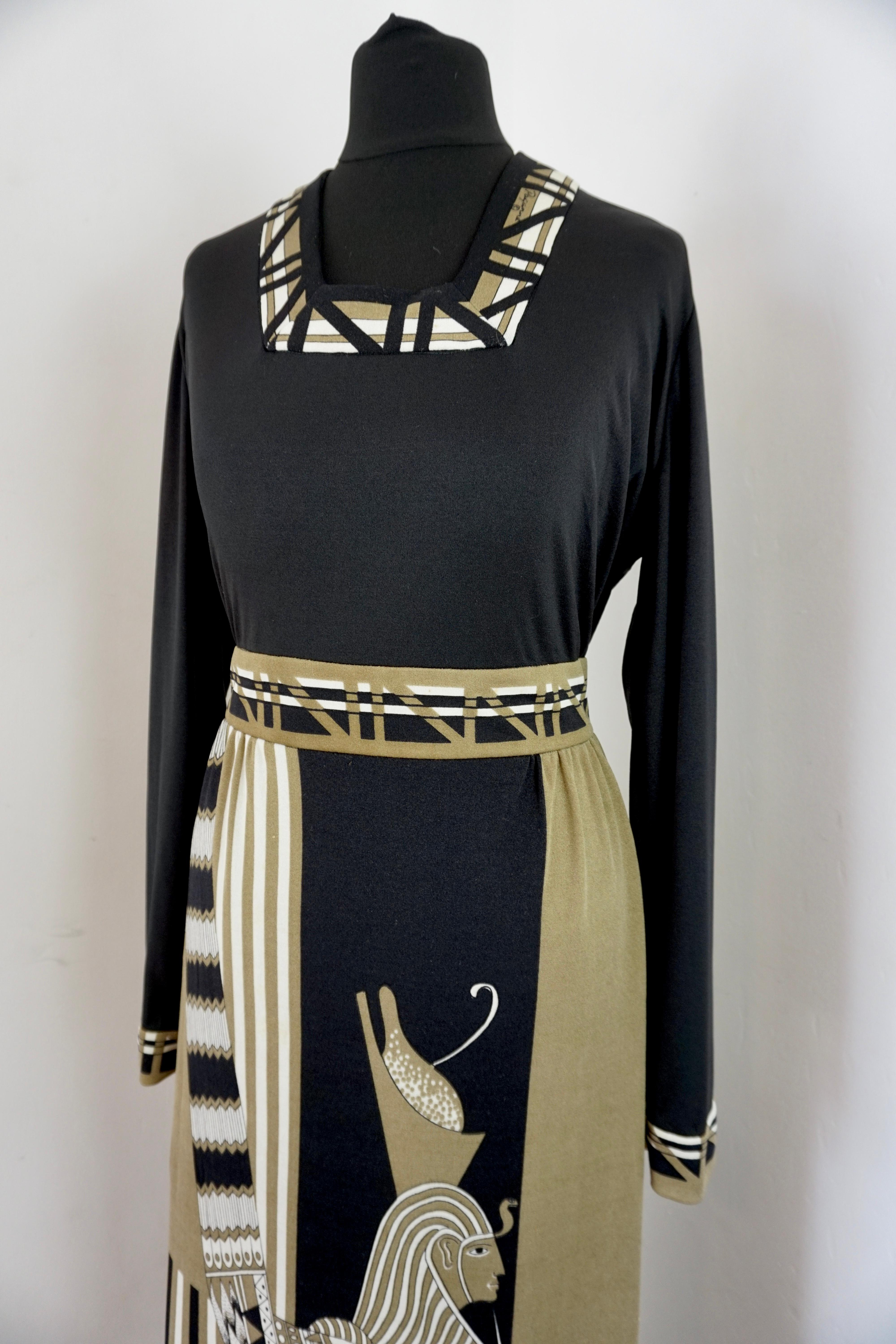 Incredible 1970s signed Paganne by Gene Berk in the famous Egyptian design. Made from the classic silk jersey combining a khaki green in a monochrome design.
Labelled a size 16