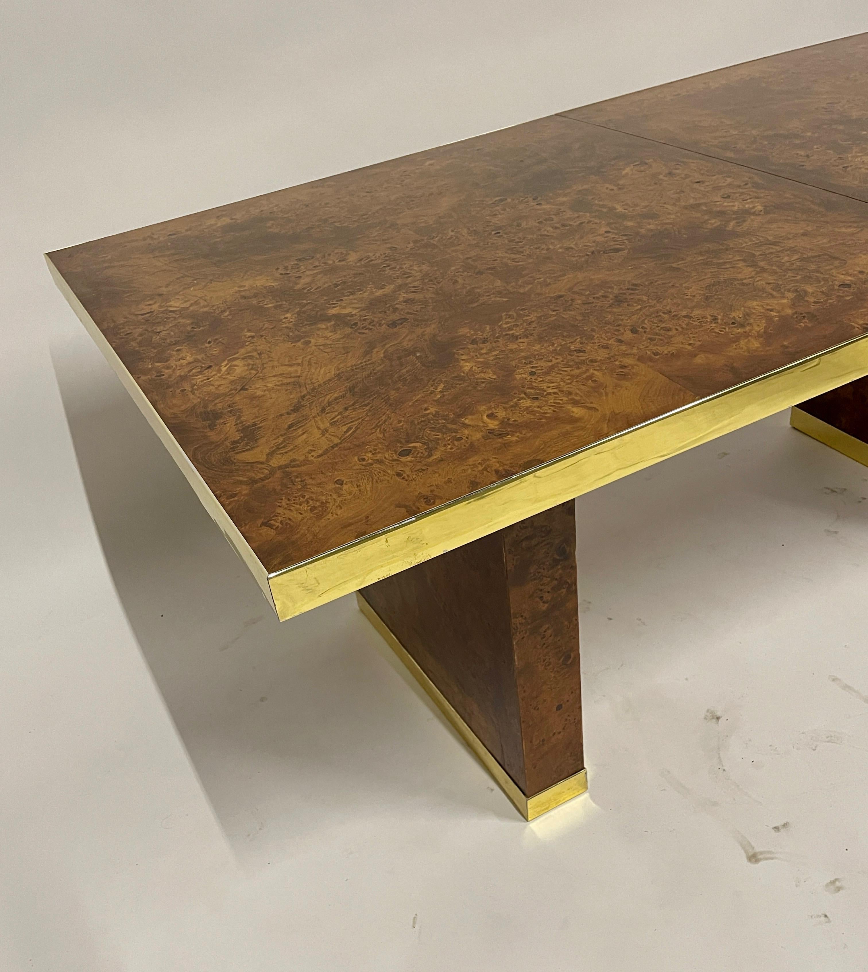 Elegant signed Pierre Cardin olive burl dining table with brass accents. Measures 6 feet long with no leaves and has two 18