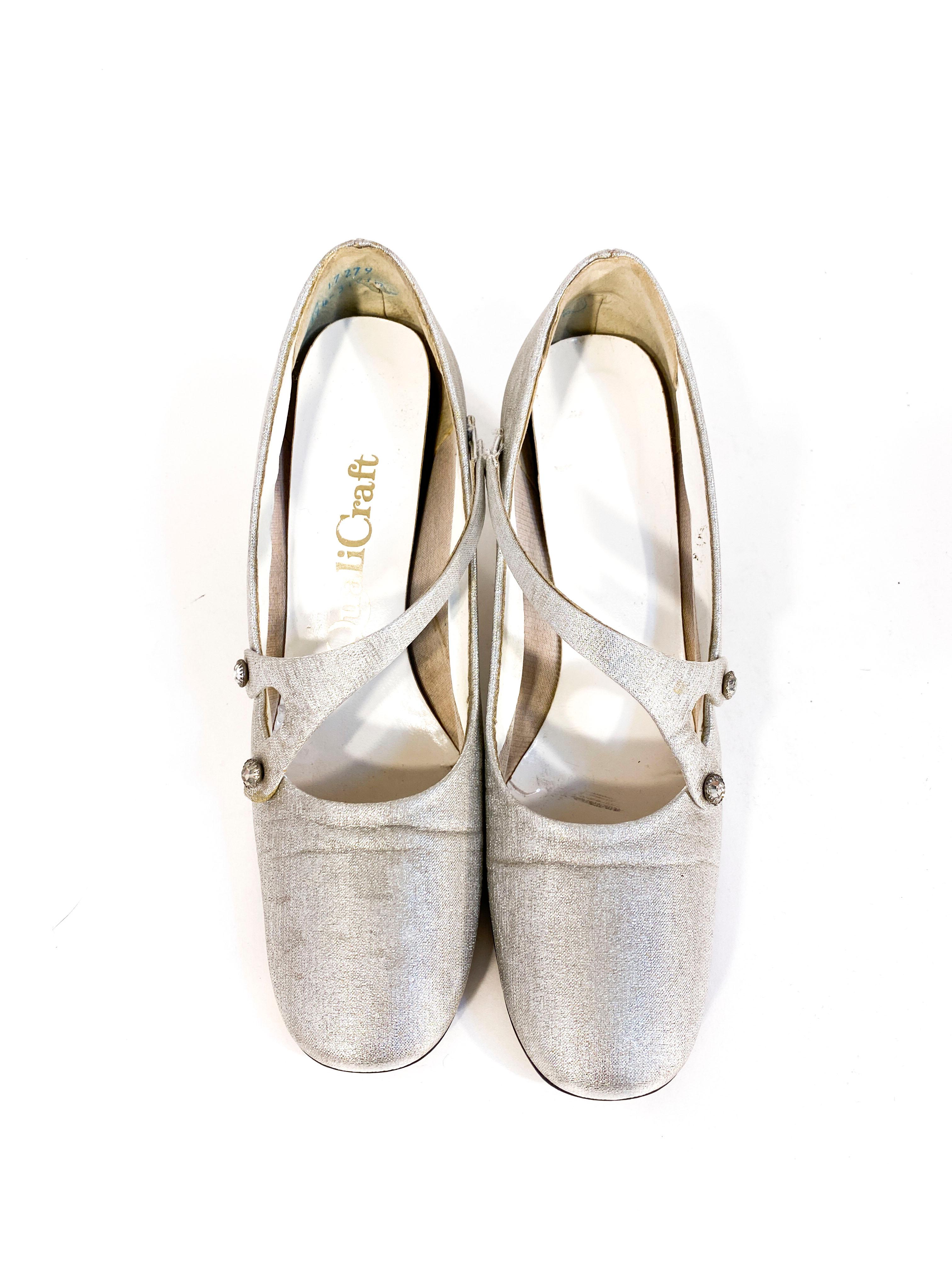 1970s silver metallic Mary Jane heels with typical squared-off toe, elasticized strap adorned with lace rhinestones. The chunky heel measures 5.2 inches high.