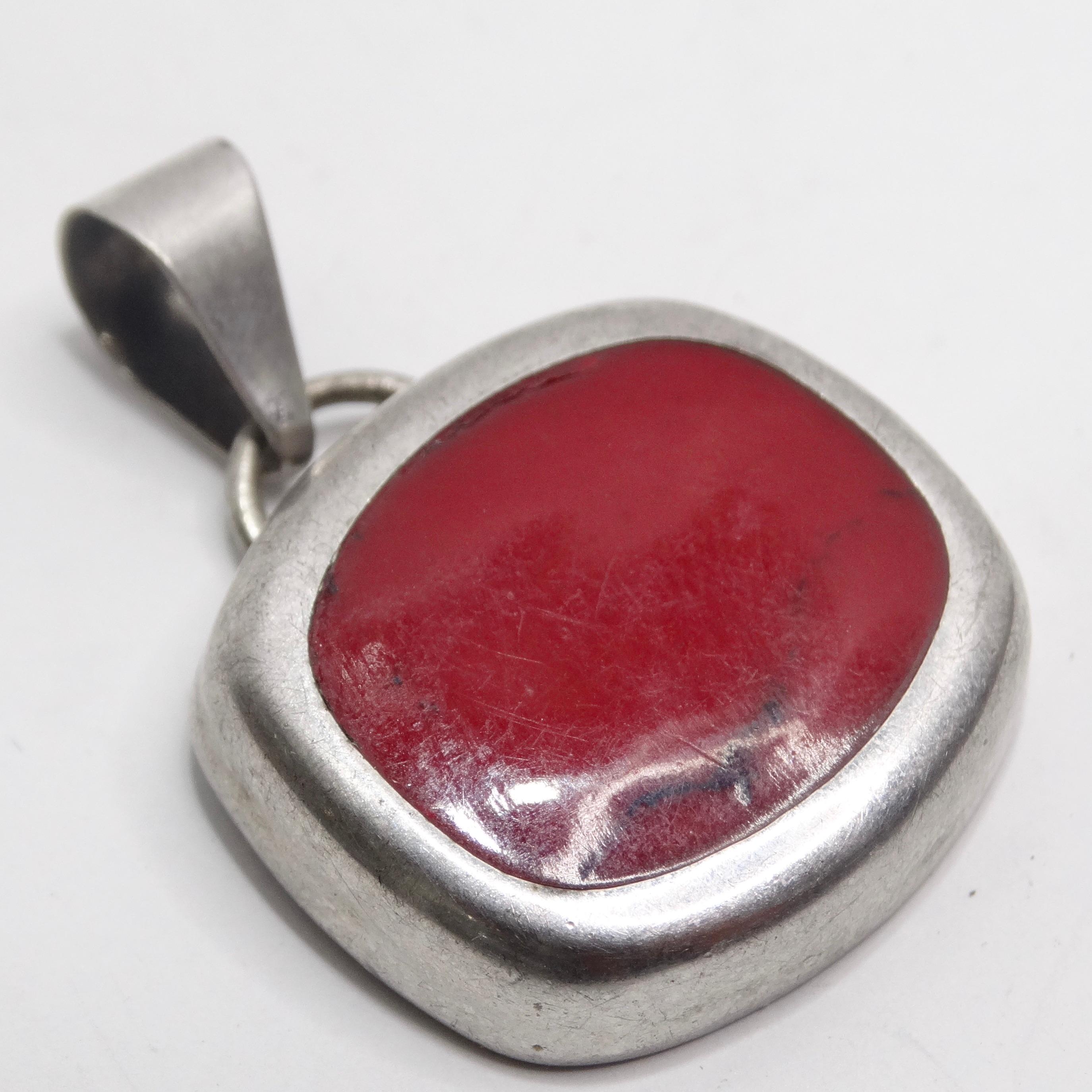 Introducing the 1970s Silver Native American Strong Red Carnelian Stone Pendant—a timeless piece that seamlessly blends the craftsmanship of Native American jewelry with a versatile pop of color. This pendant isn't just an accessory; it's a wearable