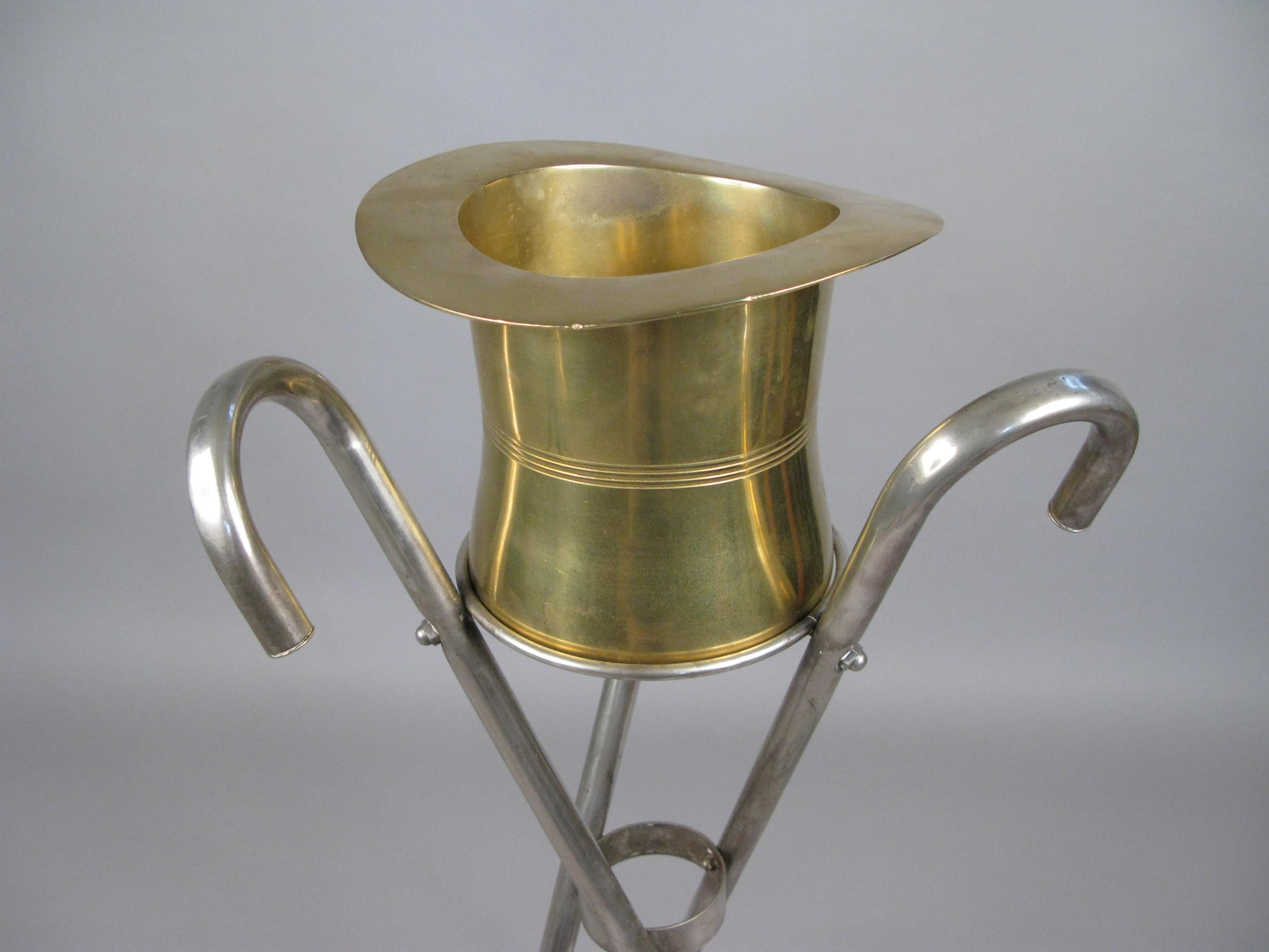 A very unique vintage 1970s silverplate top hat form champagne bucket on its stand formed with three canes.