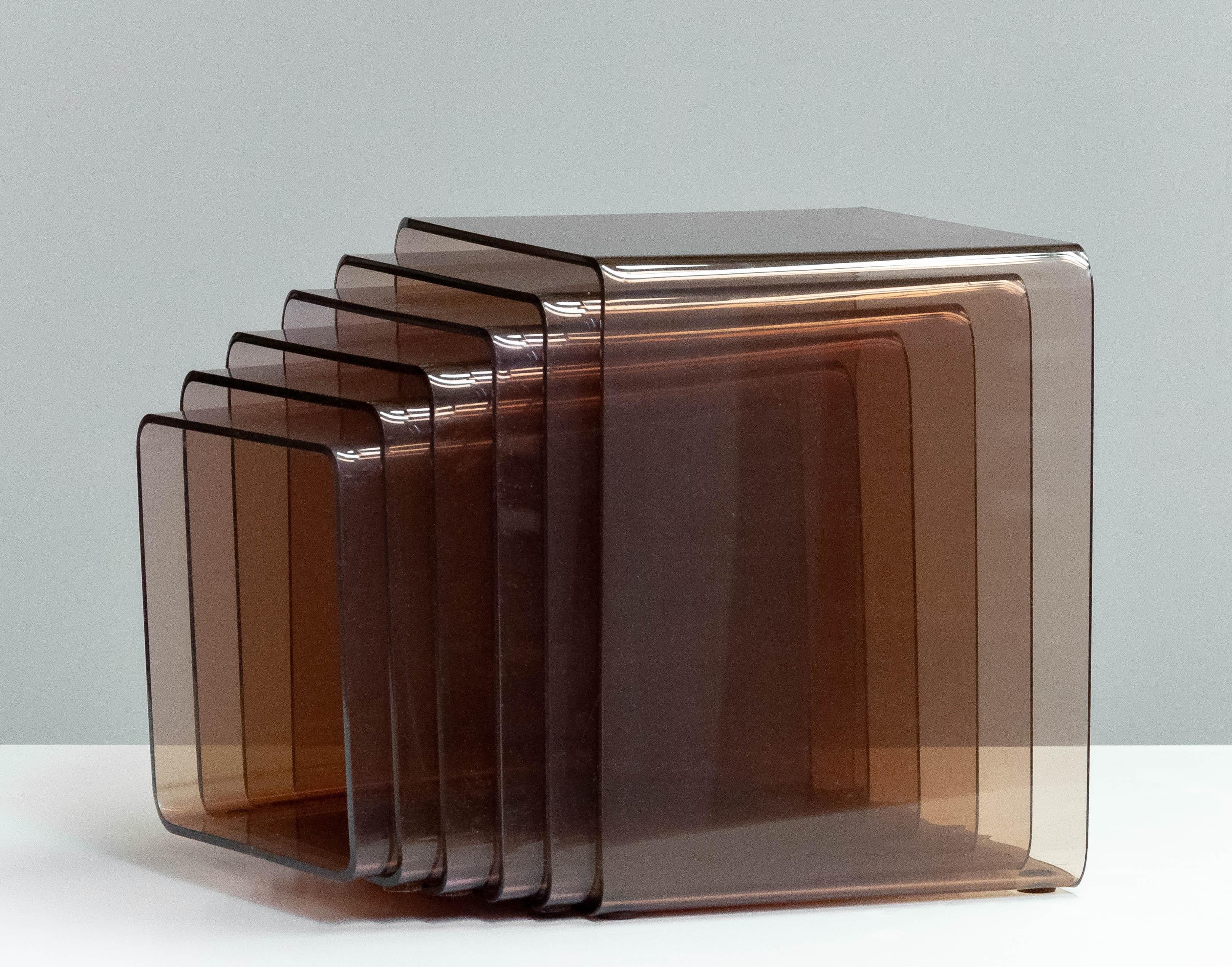 Large 1970s moderen set of six matching nesting tables in fumé / brown lucite designed by Michel Dumas for Atelier Dumas Roche Bobois and sold in the time by Roche Bobois in France.
All six tables are in overall good and original condition.
