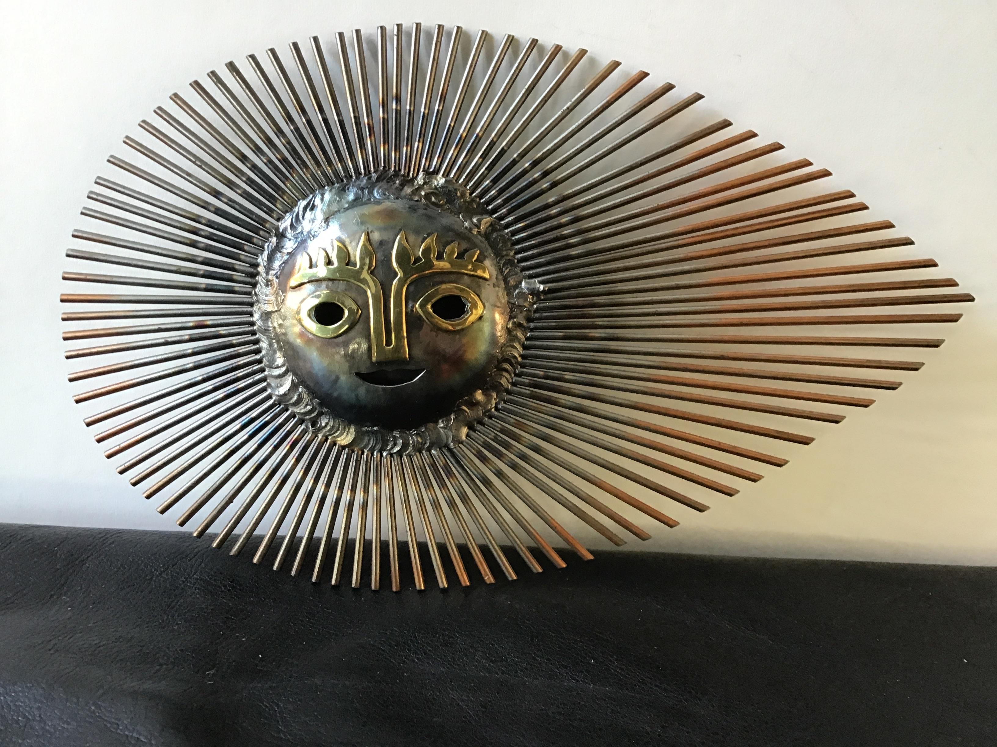 1970s Mexican steel sunburst wall hanging with brass accents.