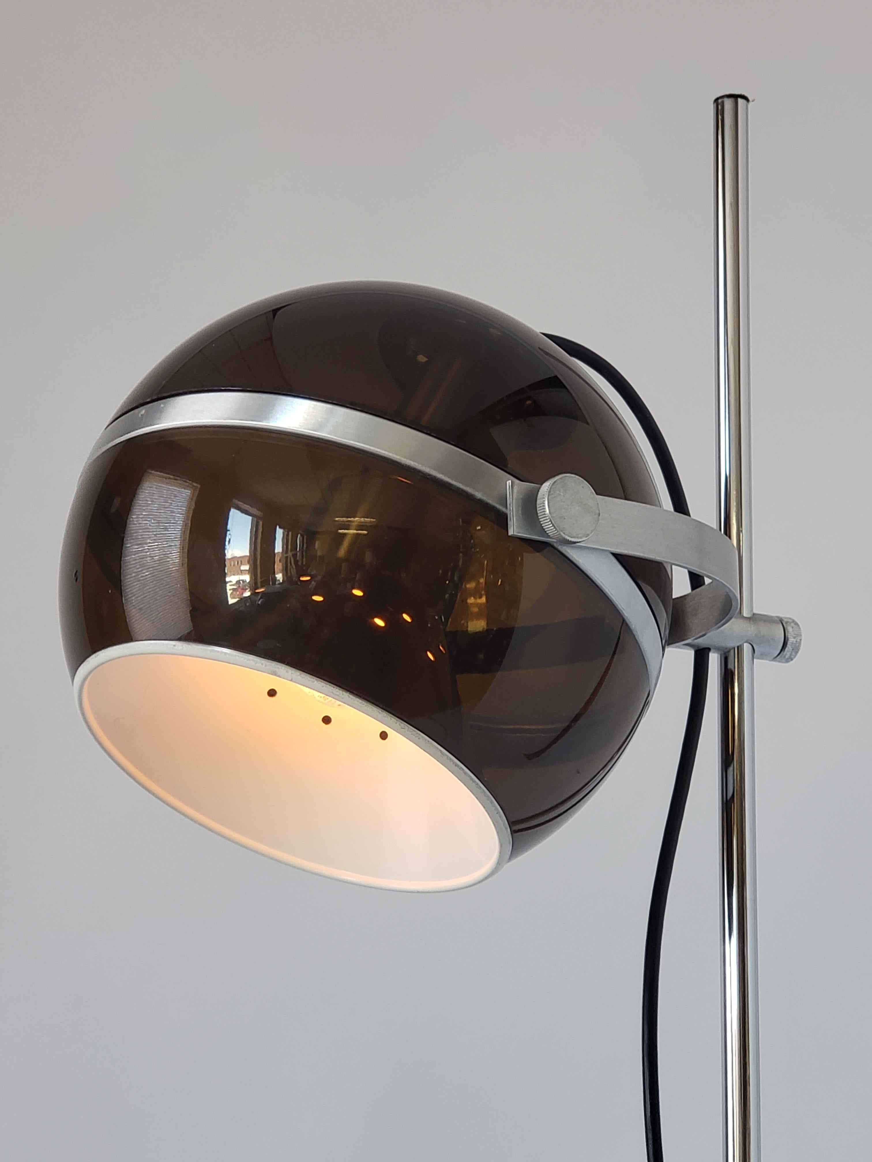 Well made floor lamp with a dark smoked acrylic shade fitted with an enameled vented aluminium diffuser.
 
Rotate in all direction, slide and lock anywhere on pole. 

Contain one E26 size socket rated at 60 watt max. 

Switch on cord.