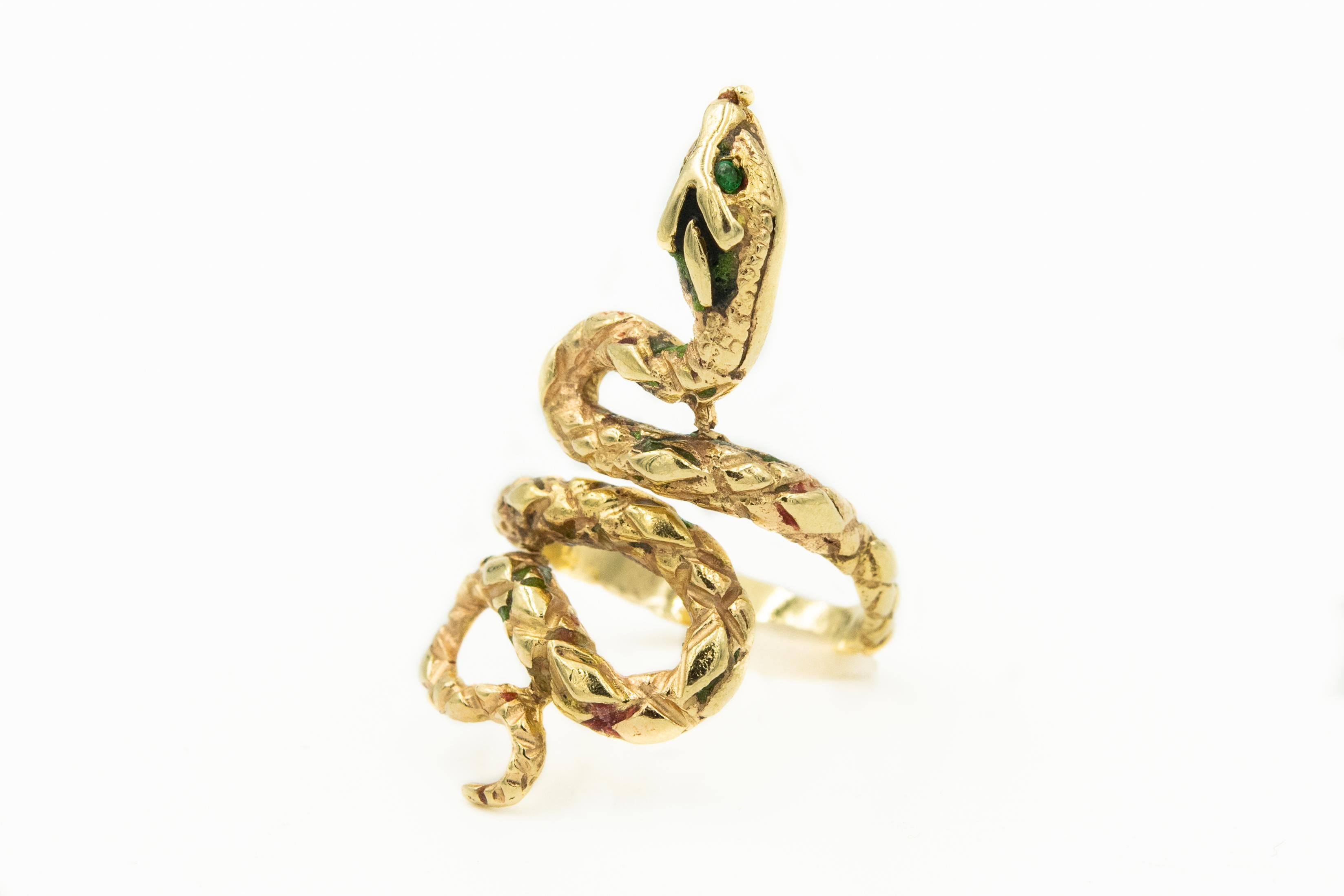 Elongated snake ring featuring a diamond pattern design along its back.  The head has green enamel and emerald eyes on a 14k yellow gold body.  Originally the body had enamel but over the years it has worn off.
US size 7