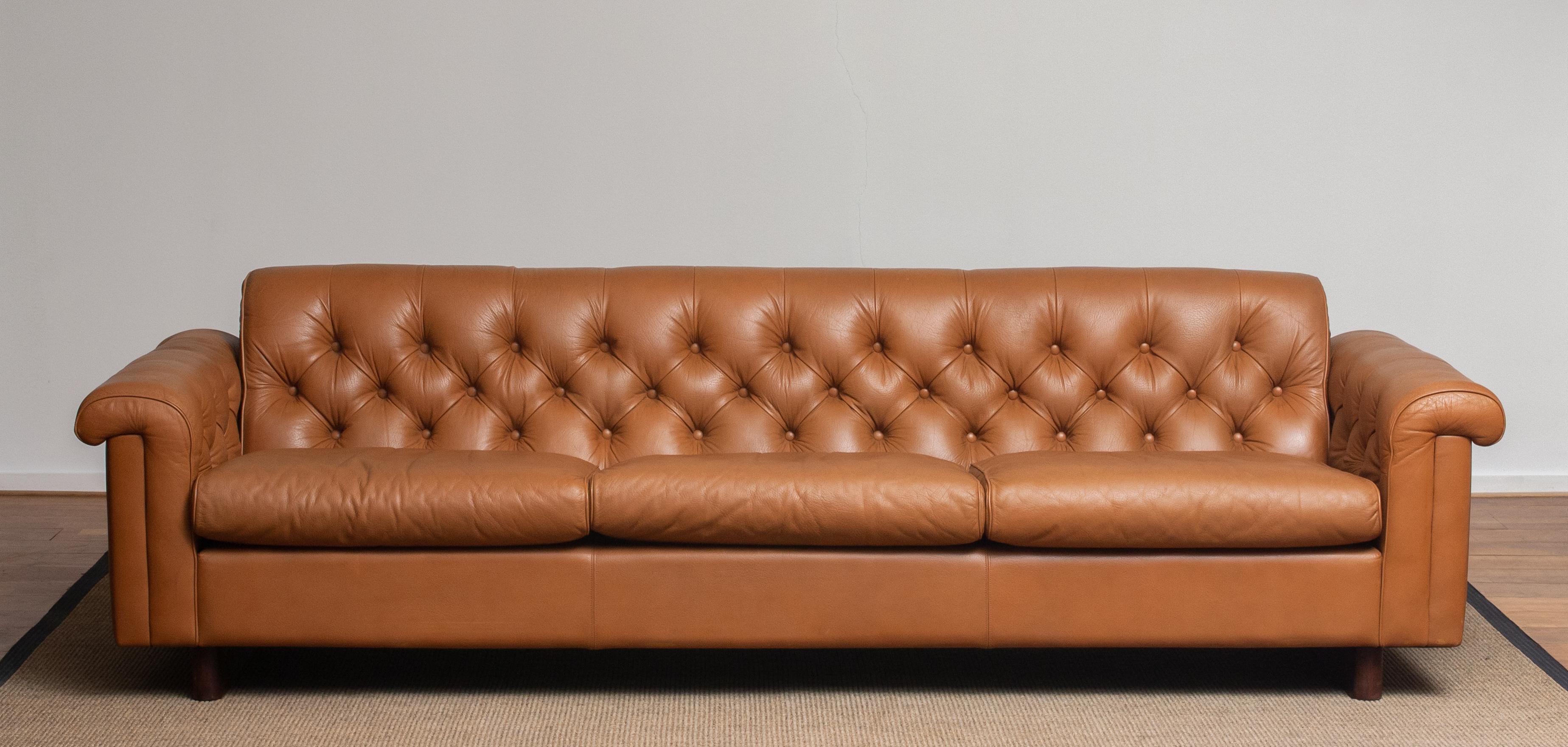 Absolutely rare and beautiful ( Chesterfield model ) sofa in camel color tufted leather from the second half of the 70's designed by Karl Erik Ekselius for JOC Design Vetlanda in Sweden. (Labeled)
This sofa feels soft and sits extremely