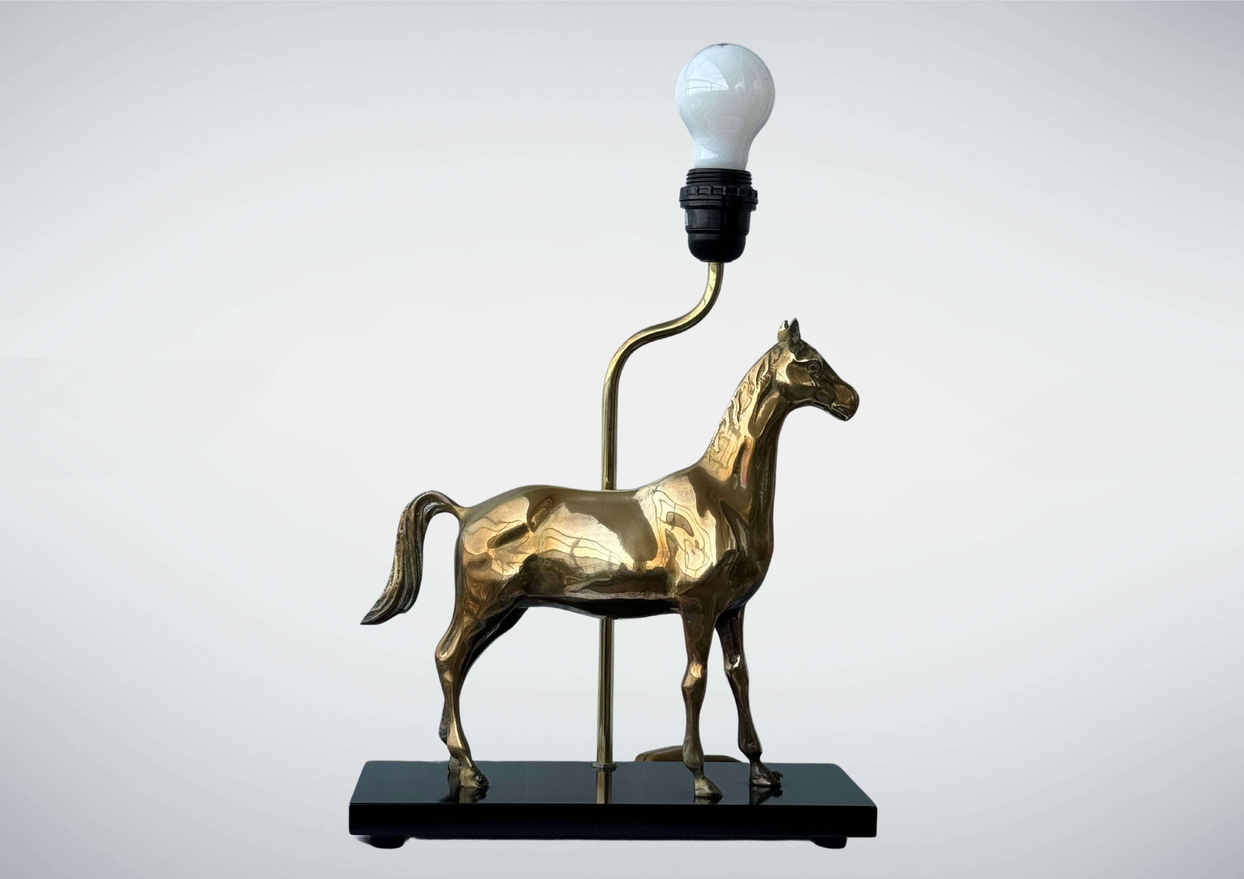 A 1970s brass horse table lamp by Deknudt Belgium
Equestrian themed, depicting an image an elegant stallion.
Mounted on a sleek black lacquered platform.
Solid brass gorgeous horse sculpture, very charming.
Beautifully finished.
The horse sculpture