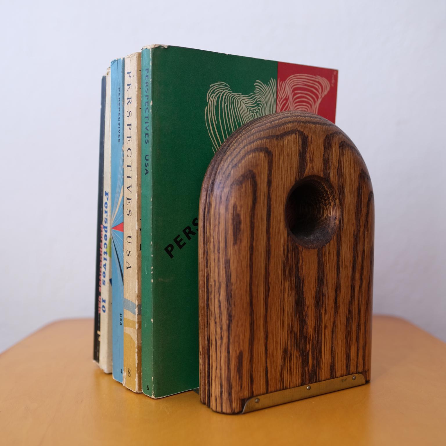 A great pair of modernist oak and brass bookends from the 1970s. Solid wood with rounded edges and carved line detail.