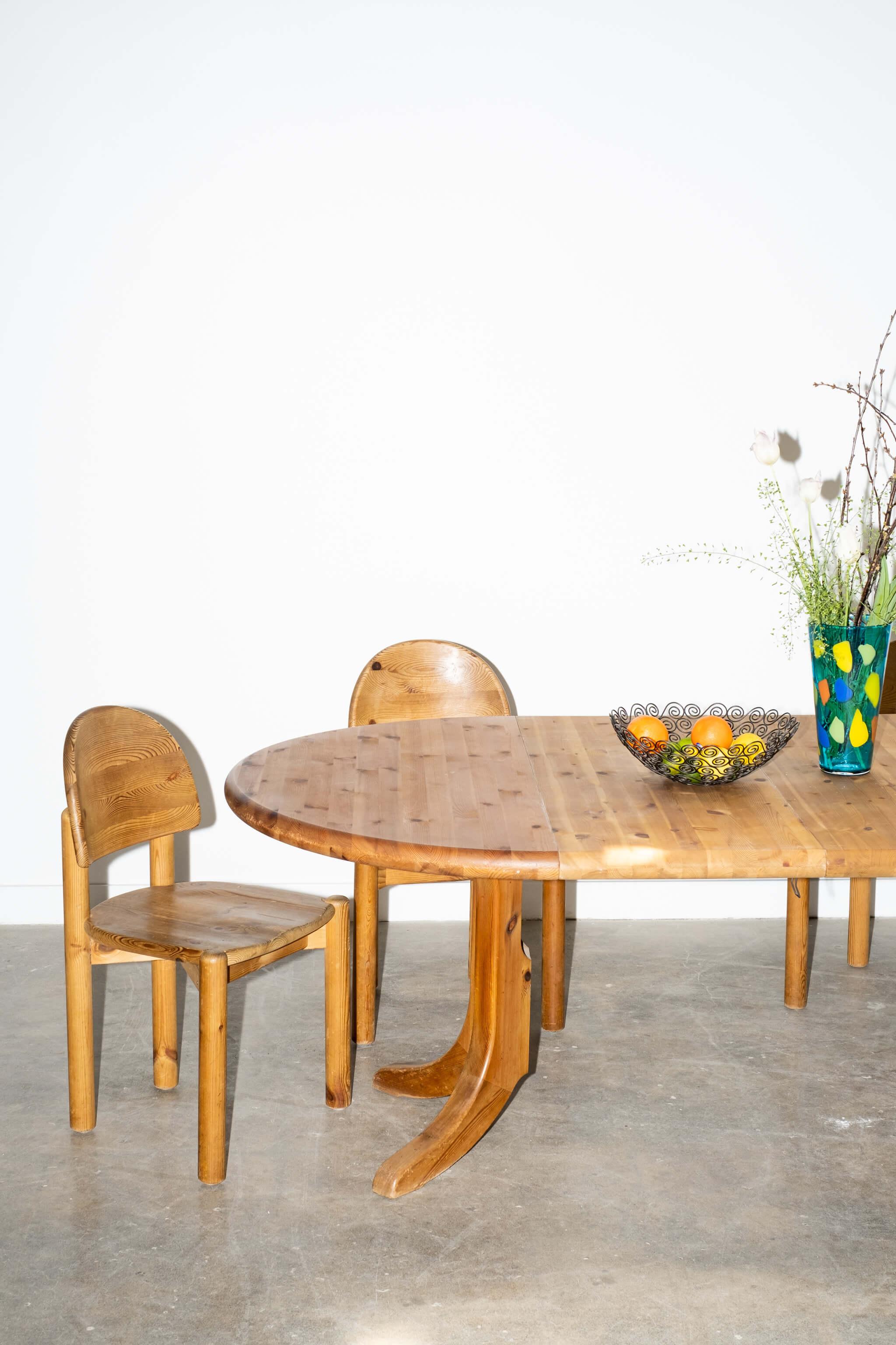 This solid pine dining table, designed by Rainer Daumiller and manufactured by Hirtshals Savvaerk in the 1970s, also includes 2 extensions. A round table with no leaves, or customize/extend to an oval dining table, with one or 2 leaf additions.