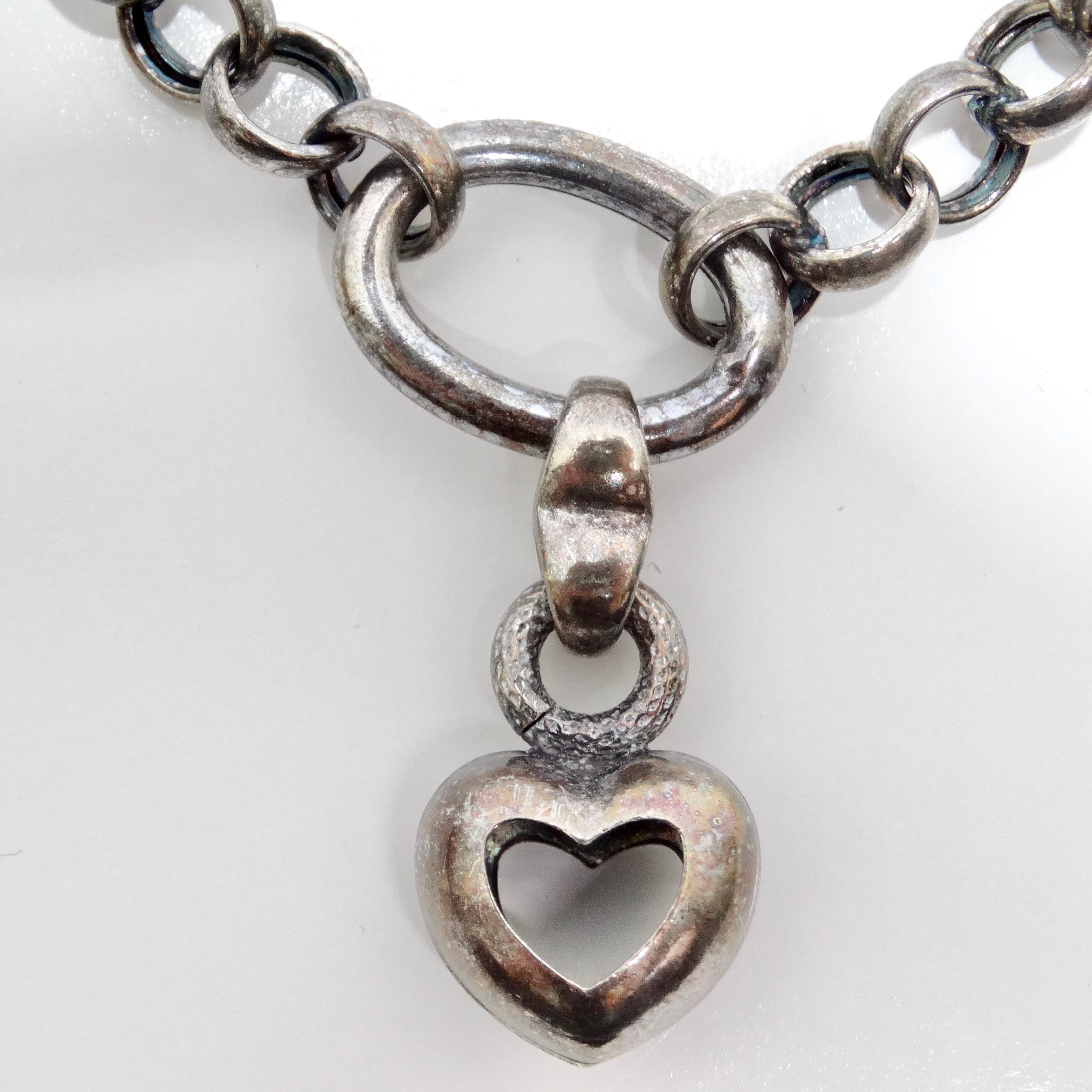Introducing the 1970s Solid Silver Heart Charm Bracelet, a charming vintage piece that brings a touch of sweetness and elegance to any jewelry collection. This beautiful bracelet features a pure silver chain with an adorable dangling heart charm,