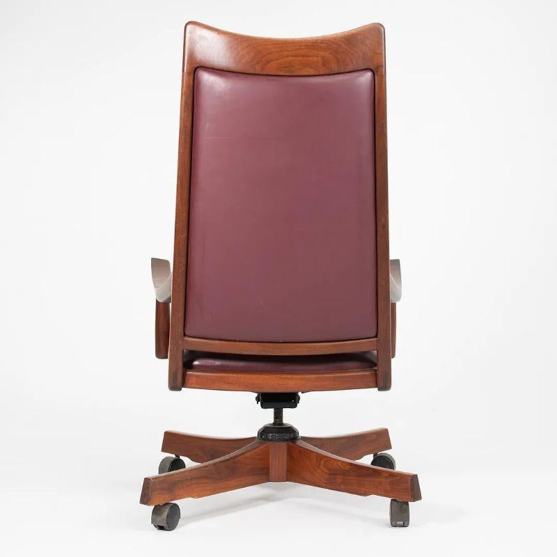 This is a rare circa 1970s swiveling desk chair that was hand crafted by John Nyquist in Long Beach, California. Nyquist was designer and craftsman, who was involved in the studio craft movement. He created fabulously intricate and expressive pieces