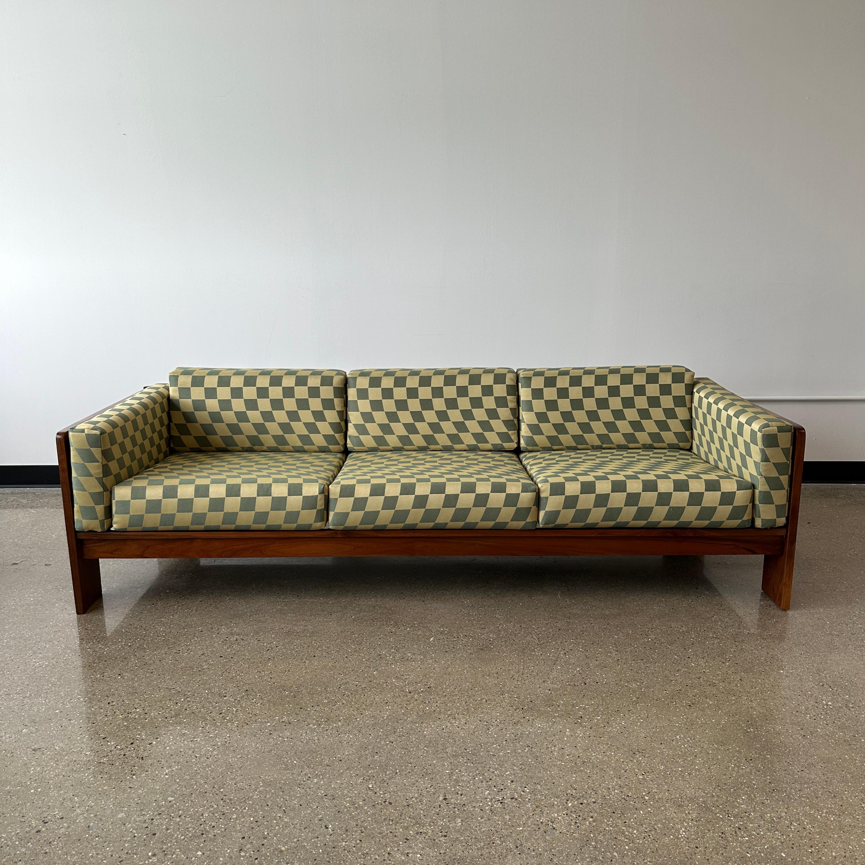 this piece has been fully refinished and restored. The cushions are new and it has been reupholstered in a vintage, dead stock wavy check fabric