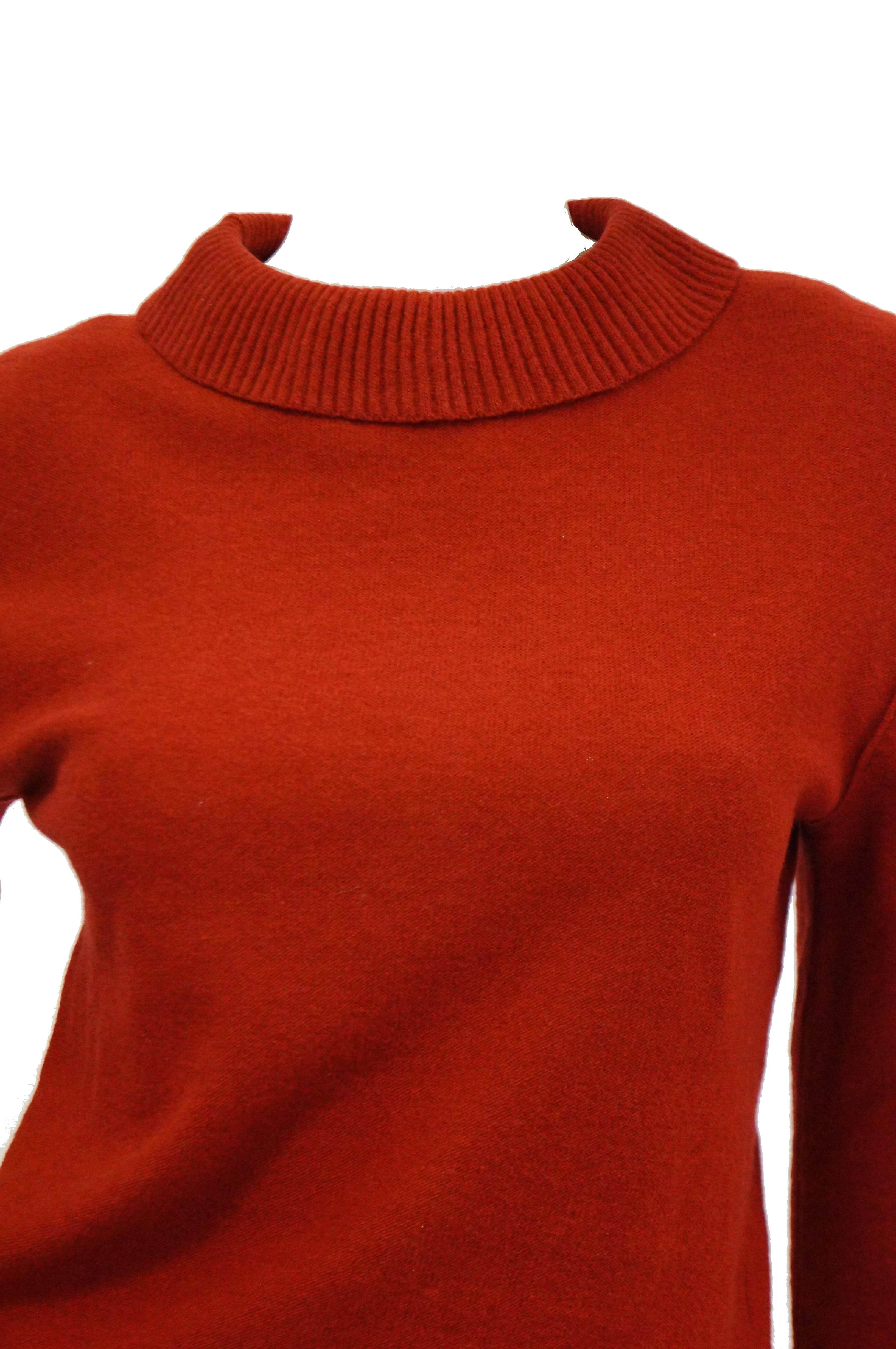 We LOVE this red sweater set by Sonia Rykiel. The virgin wool set is composed of a knee length wide knife pleat skirt with wide waist, and a loose fit long sleeve sweater with narrow rib knit, fitted waist, wide sleeve cuffs, and wide round collar.