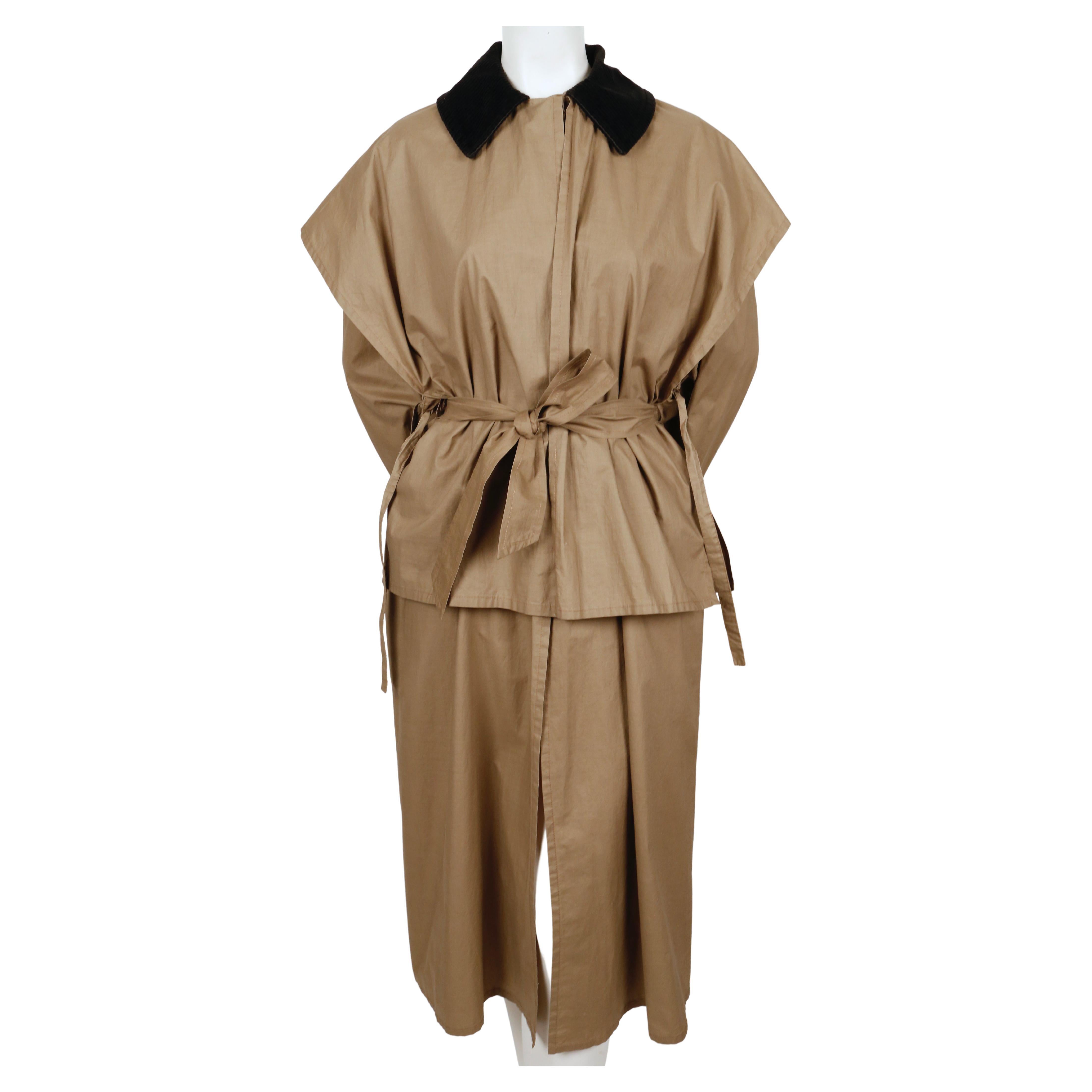 Tan, unlined, lightweight trench coat with black corduroy trim and cape detail designed by Sonia Rykiel dating to the 1970's. Cape can be worn over or under belt and has ties on each side. No size is indicated however this would fit a size 2-6