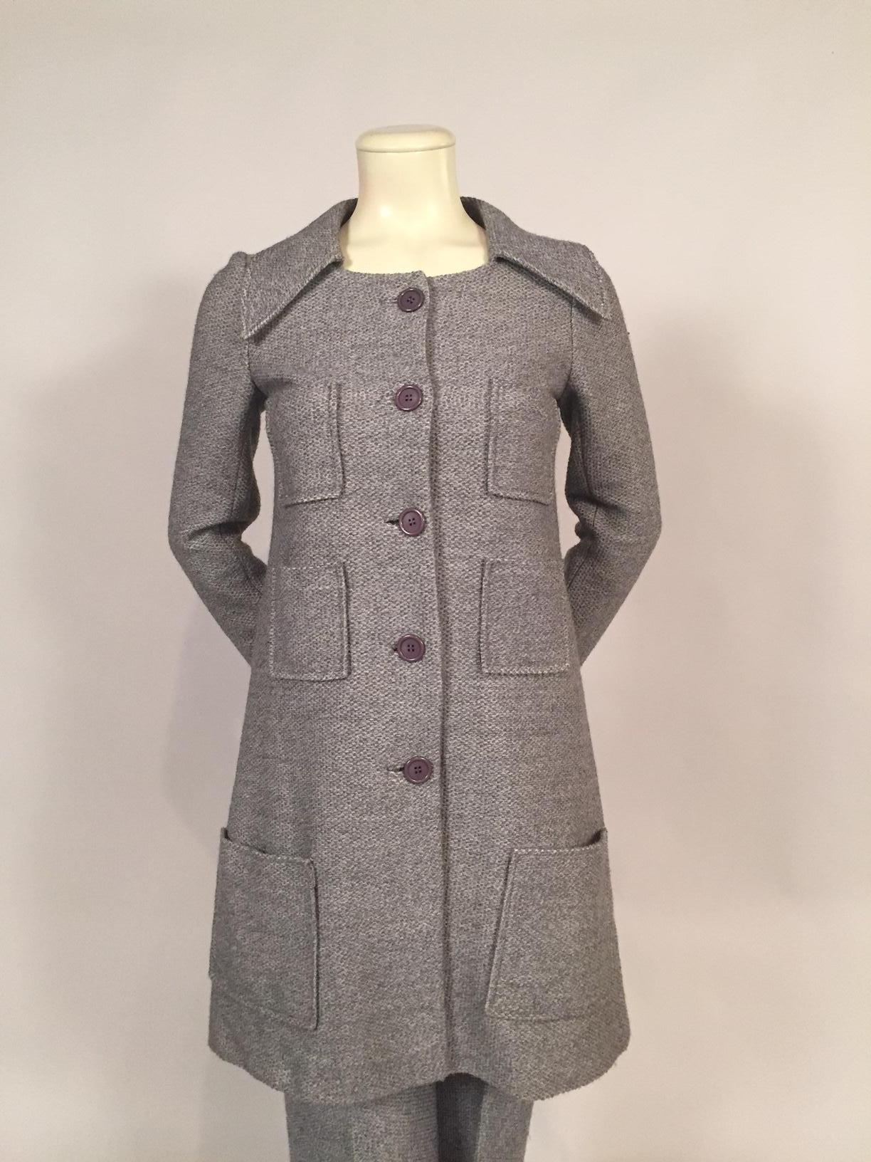 A soft grey wool tweed is used for this coat and pant ensemble from Sonia Rykiel. The coat has six patch pockets, a functional and decorative element.  There are grey buttons and bound buttonholes at the center front and on the cuffs. The coat has a