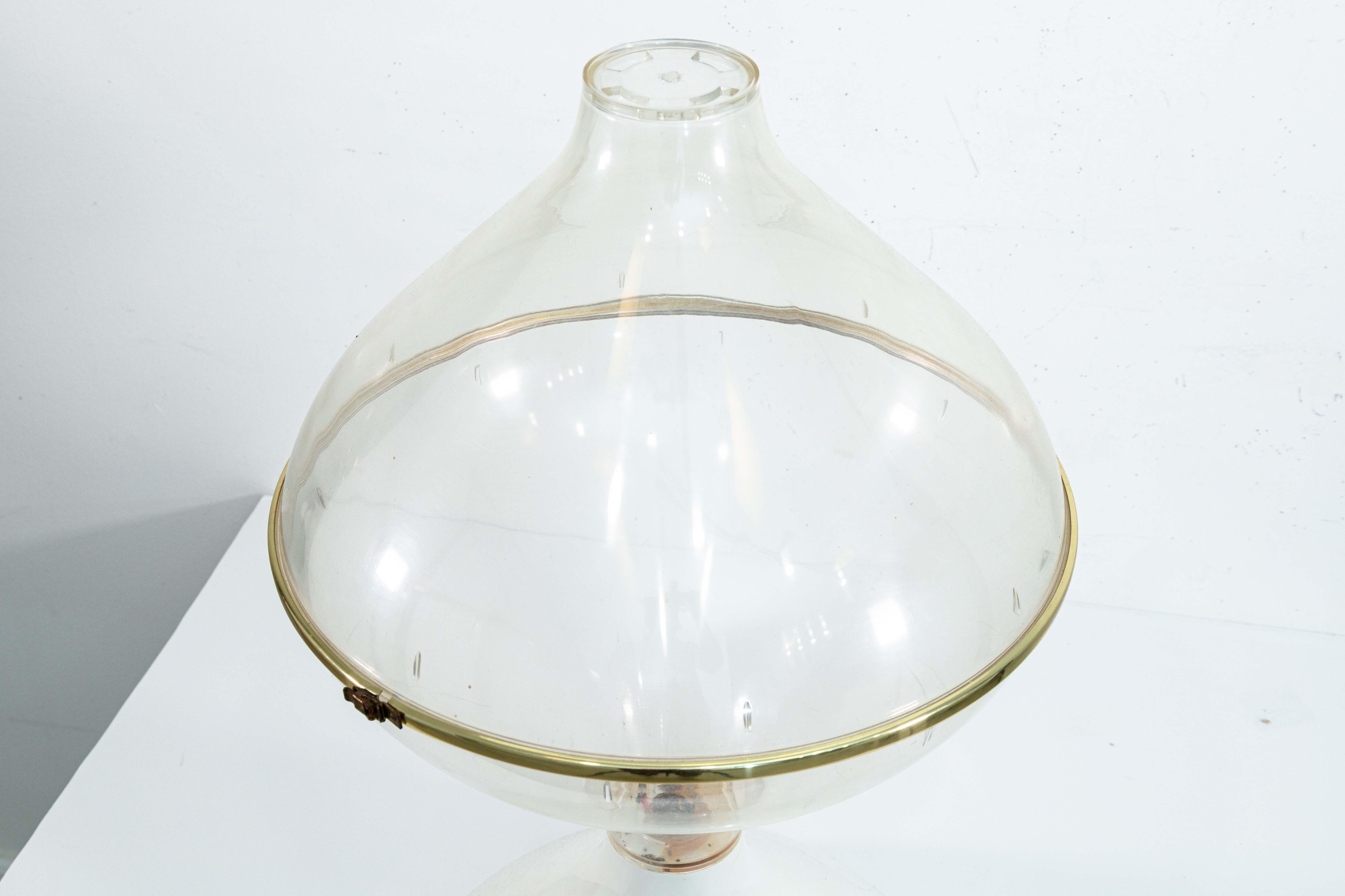 A 1970s tear drop shaped acrylic floor planter terrarium. This is s super chic space age style terrarium. This piece features a gorgeous tear drop shaped frame with a white acrylic base, and a clear acrylic container on top. The top features a two