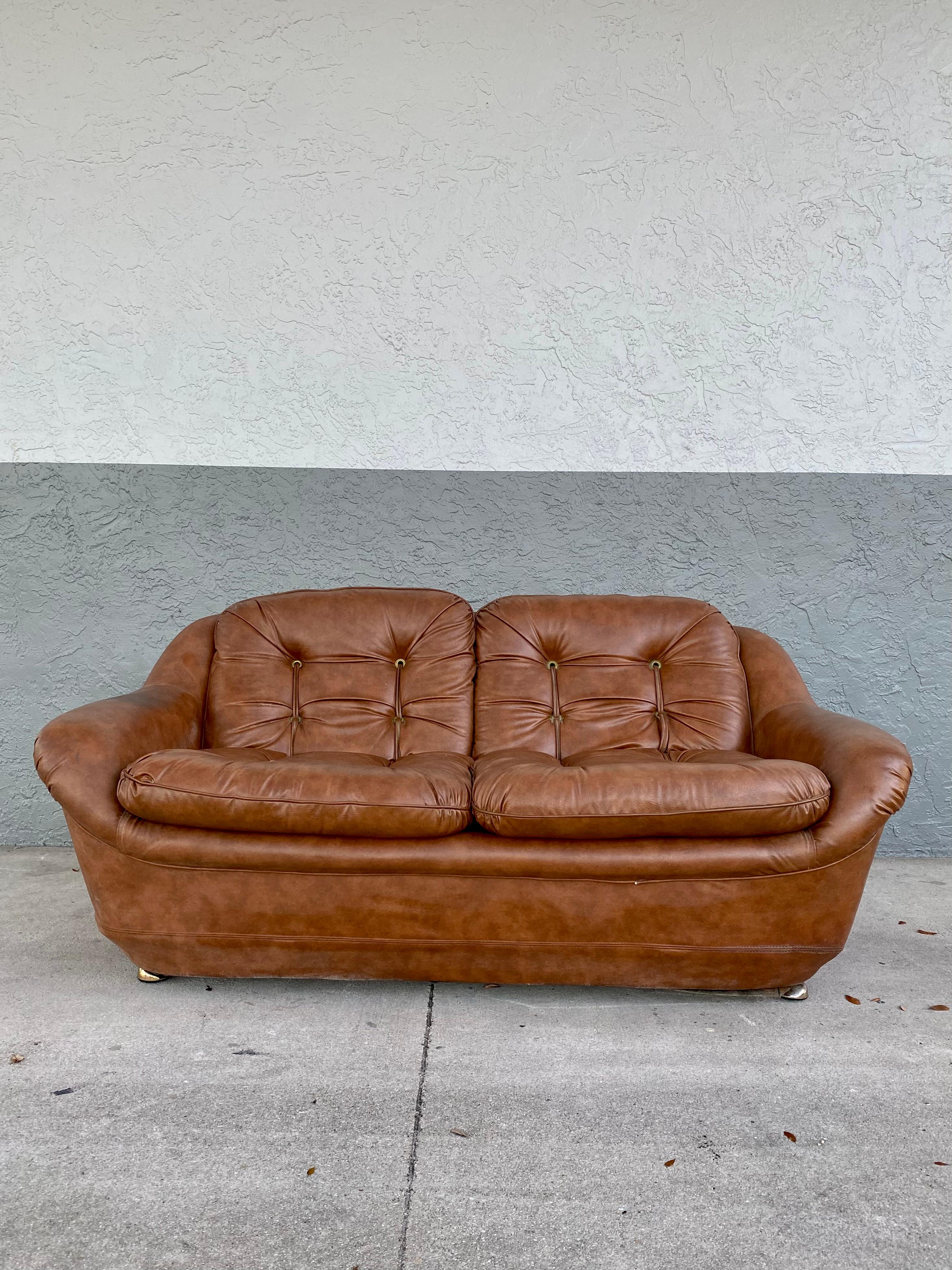 Rare and in original condition. Inherently stylish and intriguing! For your consideration is a sleek and stylish love seat sofa in the style of Michel Cadestin, circa 1970. Elegant from every angle-his best sofa design. Dripping with style makes