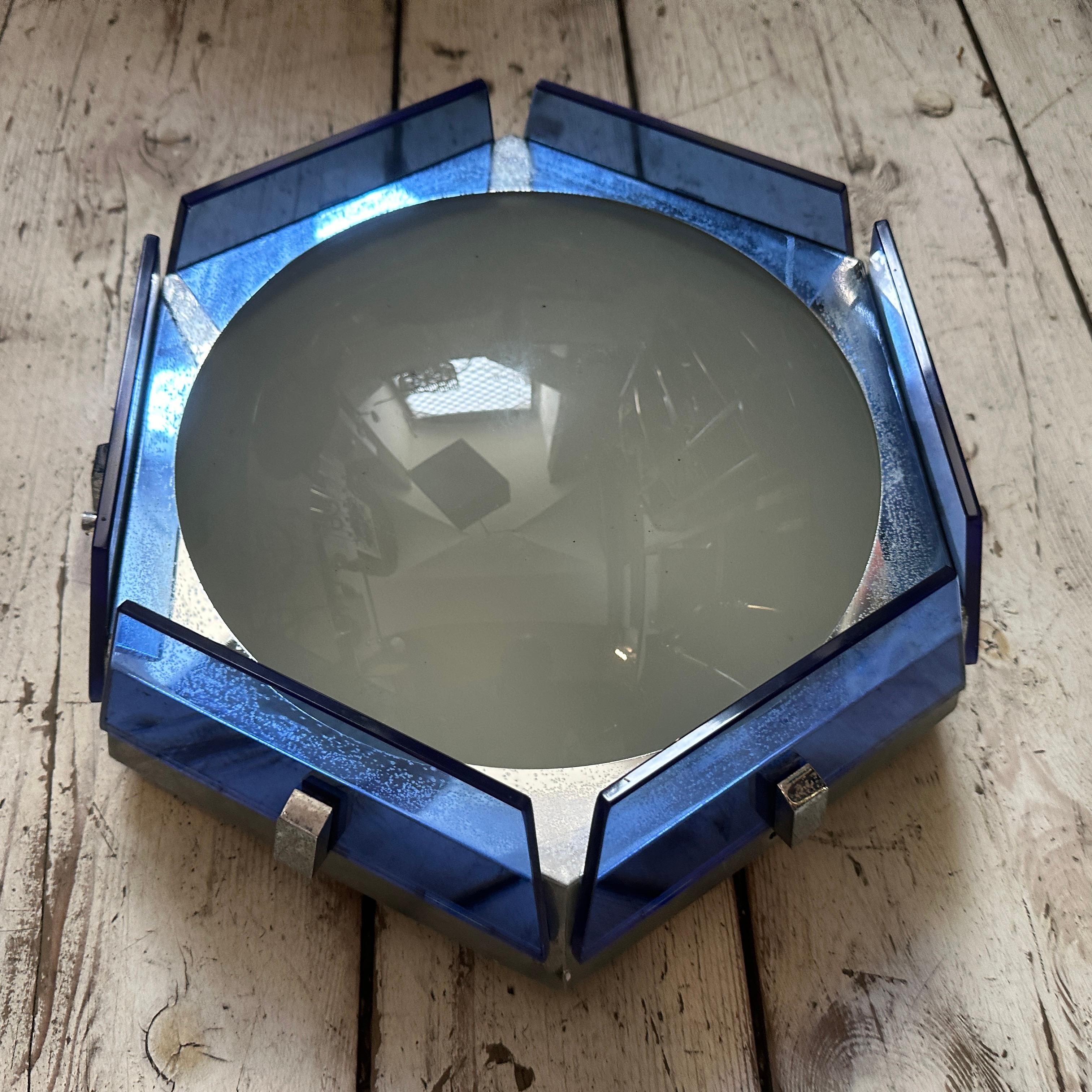This is a hexagonal ceiling light from the 1970s, designed in the Space Age style, made by the Italian company Veca. Space Age design, inspired by the space exploration era, is known for its futuristic, geometric shapes and use of innovative