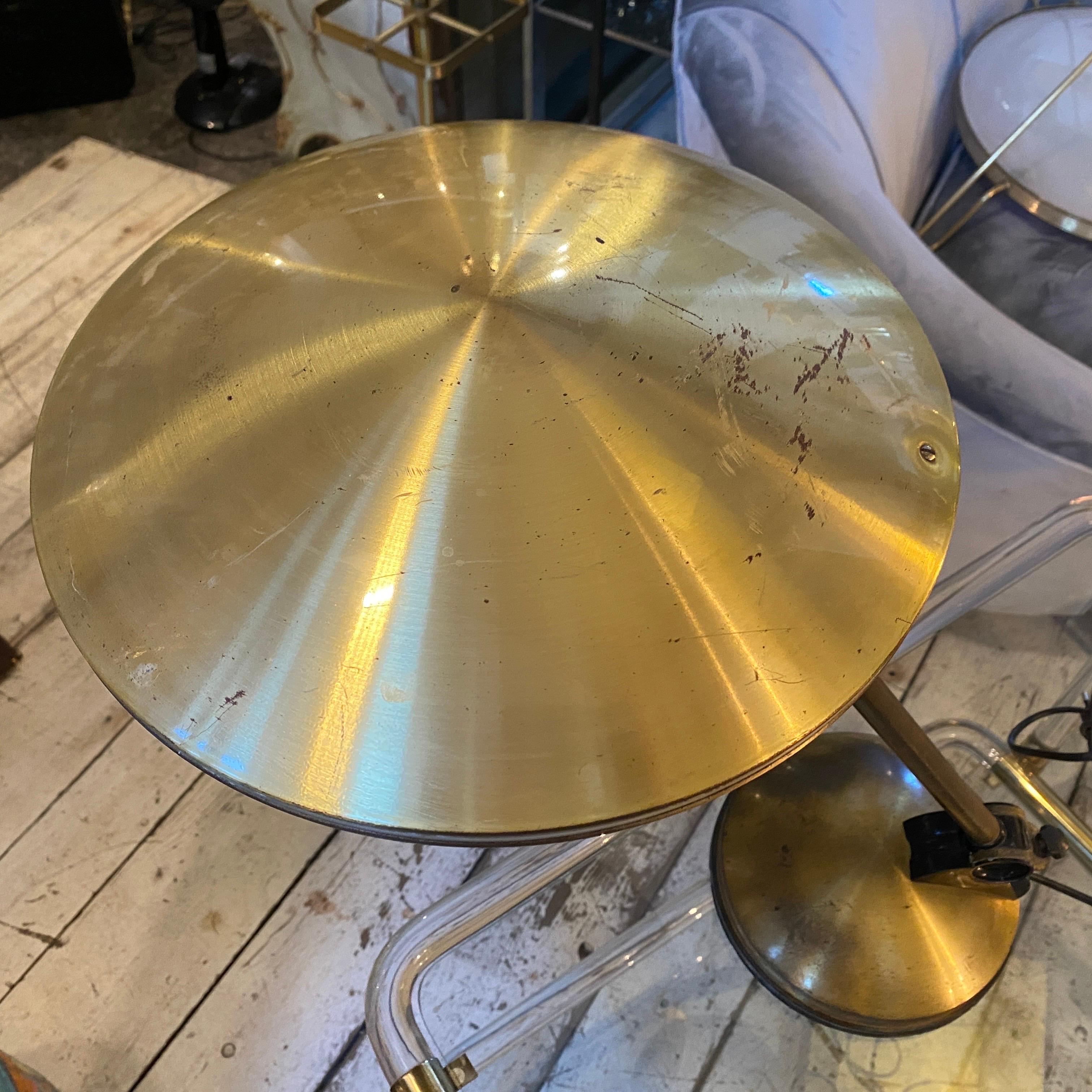 A gilded metal Ufo desk lamp designed and manufactured in Italy in the Seventies. It has normal signs of use and age that gives it a superb vintage look. It works both 110 and 240 volts and needs a regular e27 bulb. This Italian Desk Lamp represents