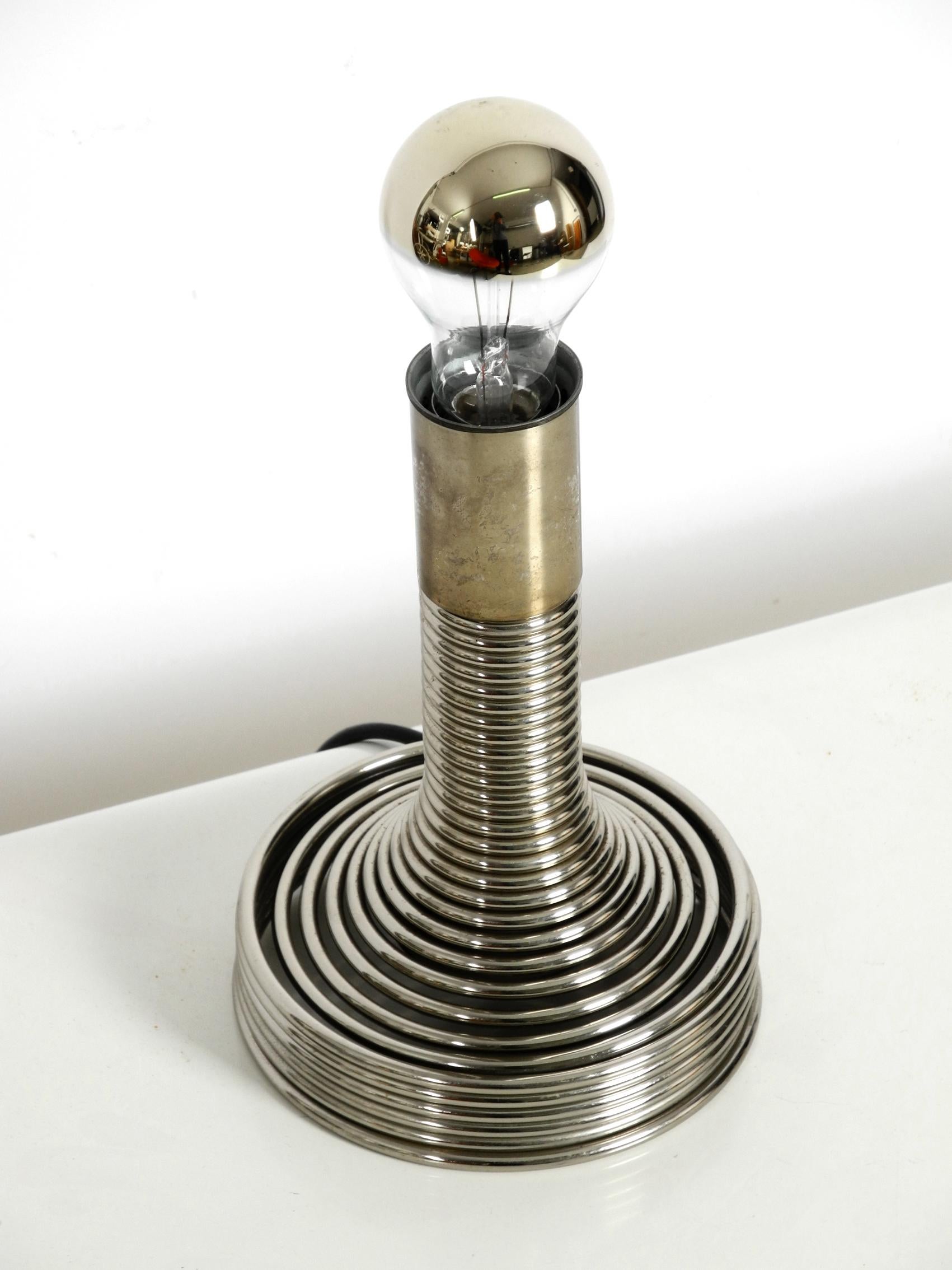 1970s table lamp by Angelo Mangiarotti for Candle. Great Space Age pop art design from the 1970s. One E27 original socket. The lamp is made entirely of chrome-plated metal. At some spots, the chorm is not so shiny anymore. There are no damages to