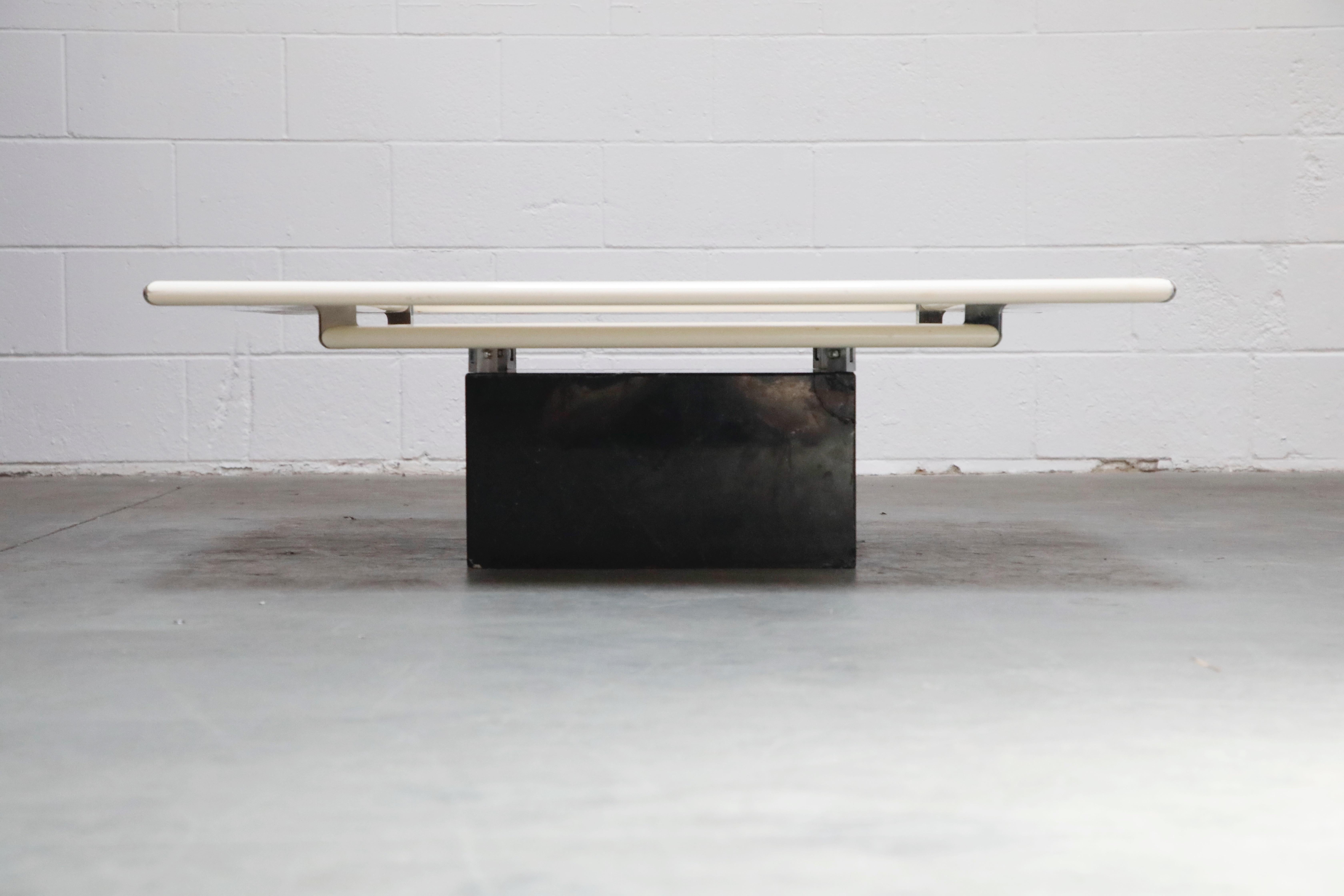 Such a cool and unique design, this futuristic space age mod B&B Italia coffee table features two tiers of lacquered wood and steel over a square marble base. 

This would work great in a Post-Modern, Mid-Century Modern, Space Age Mod,