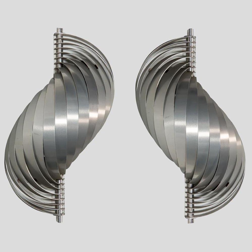 A pair of 1960s vintage swelling aluminium sconces by French designer Henri Mathieu. They are made from an original design of bent aluminium strips, which creates a soft ambient effect when lighted. This pair is in very good vintage condition and is