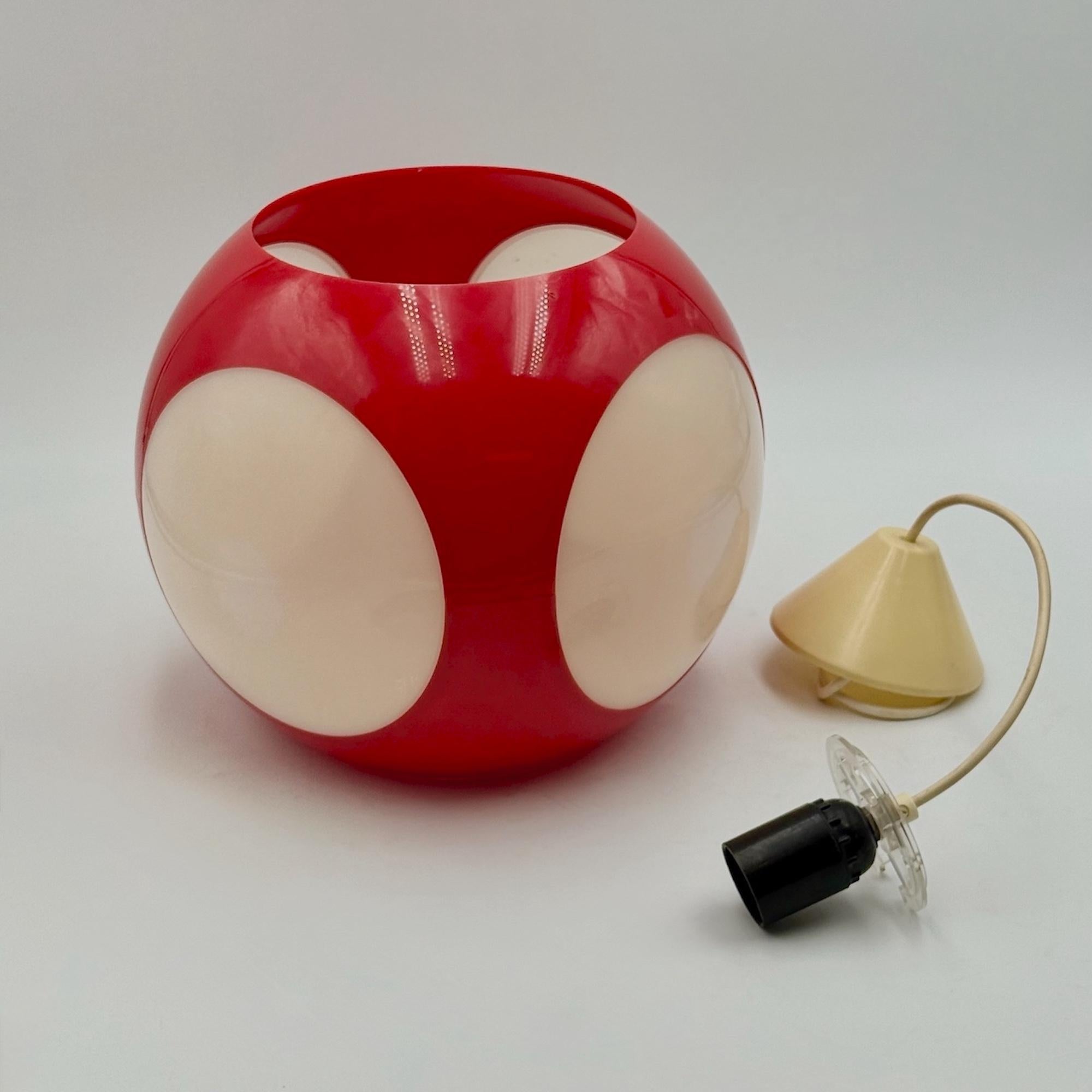 This rare Space Age pendant lamp, crafted by Belgian manufacturer Massive in the 1970s, is a striking example of retro-futuristic European lighting. The design features a vibrant red plastic sphere punctuated by four large, inset opaline diffusers