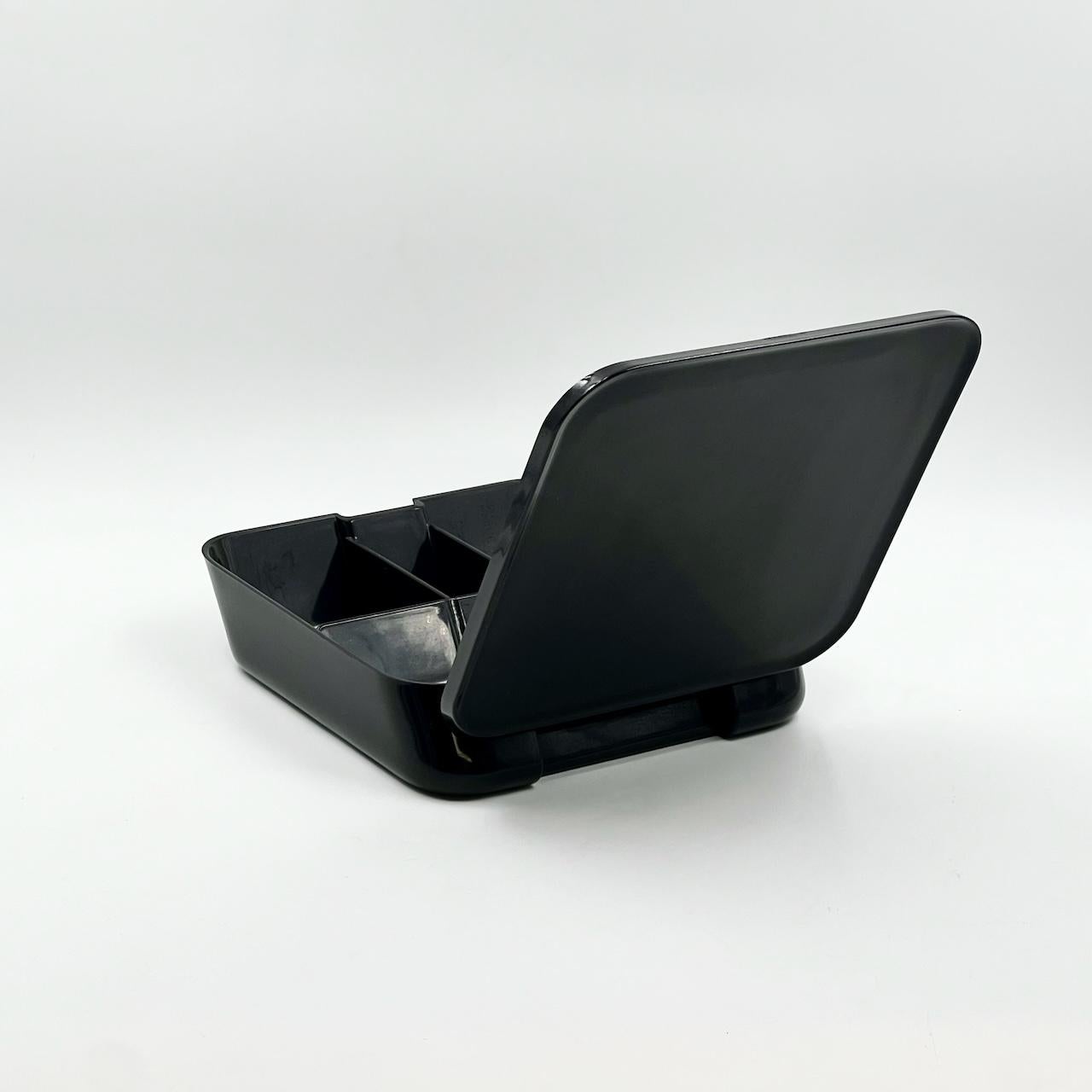 Step into the visionary realm of Space Age design with a unique and exquisite gem from the 1970s: the portable vanity set, masterfully crafted by the renowned Makio Hasuike for Gedy. This iconic piece transcends mere functionality, standing as a
