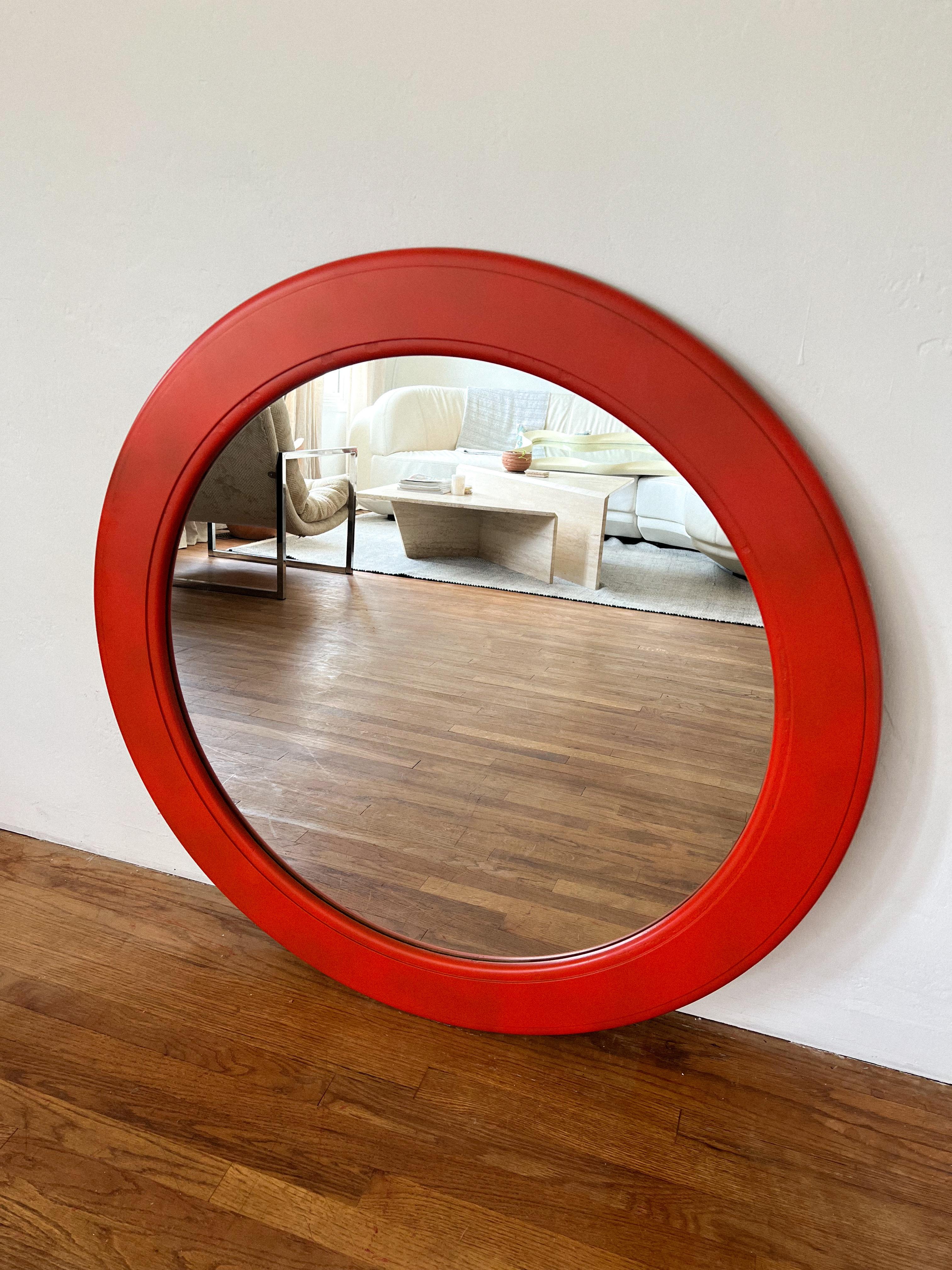 Circular wall mirror in engine red In the style of the ‘AMERICA' WALL MIRROR BY CARRARA & MATTA, ITALY 70S
