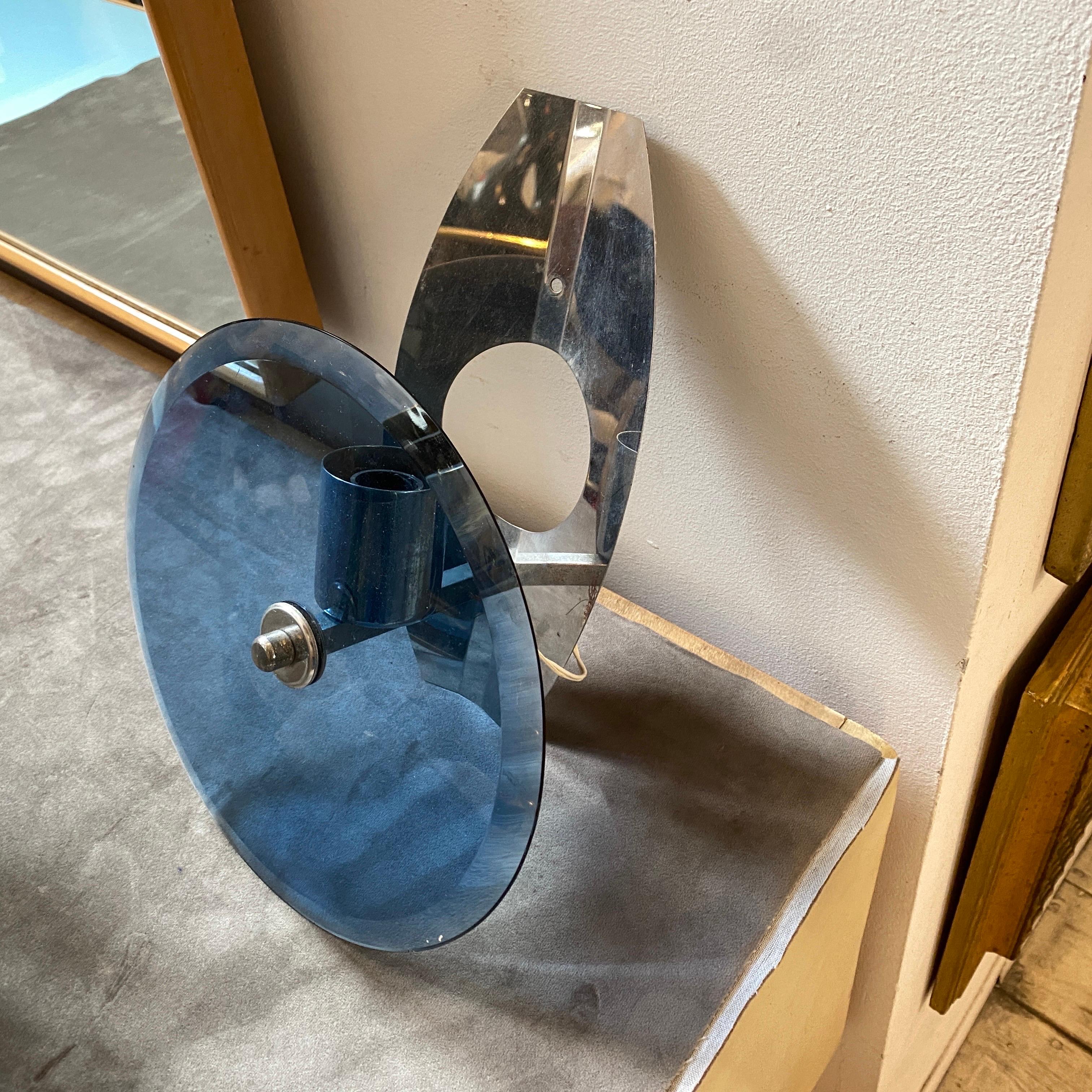 Two space age wall sconces made in Italy in the Seventies, chromed metal and blue glasses are oil perfect conditions. They operate both 110-240 volts and need two regular bulbs.