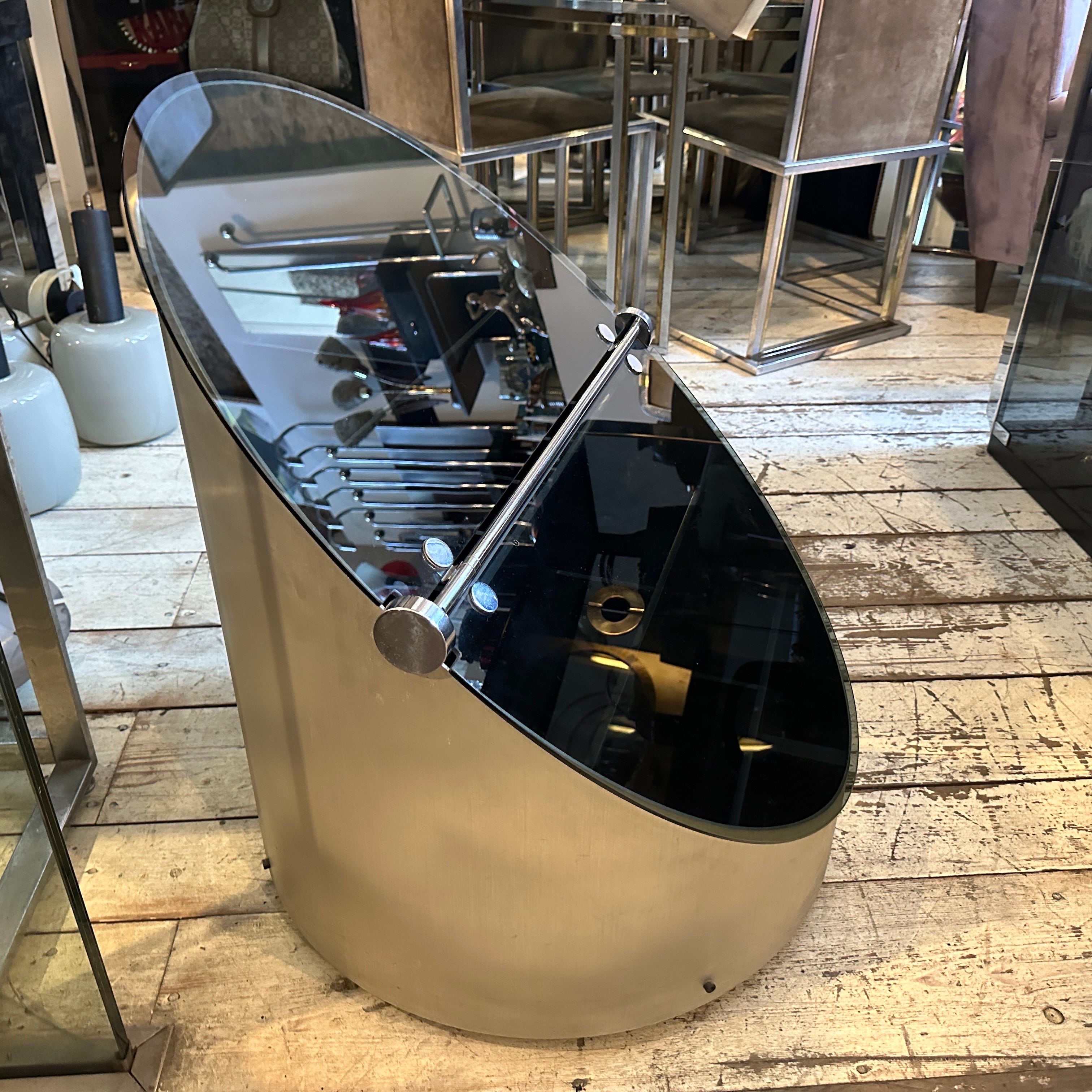 1970s Claudio Salocchi for Luigi Sormani Space Age Bar Cart in Brushed Steel and Smoked Glass.
A stunning embodiment of Italian Space Age design, this rare bar cart by Claudio Salocchi for Luigi Sormani dates to the 1970s and showcases the