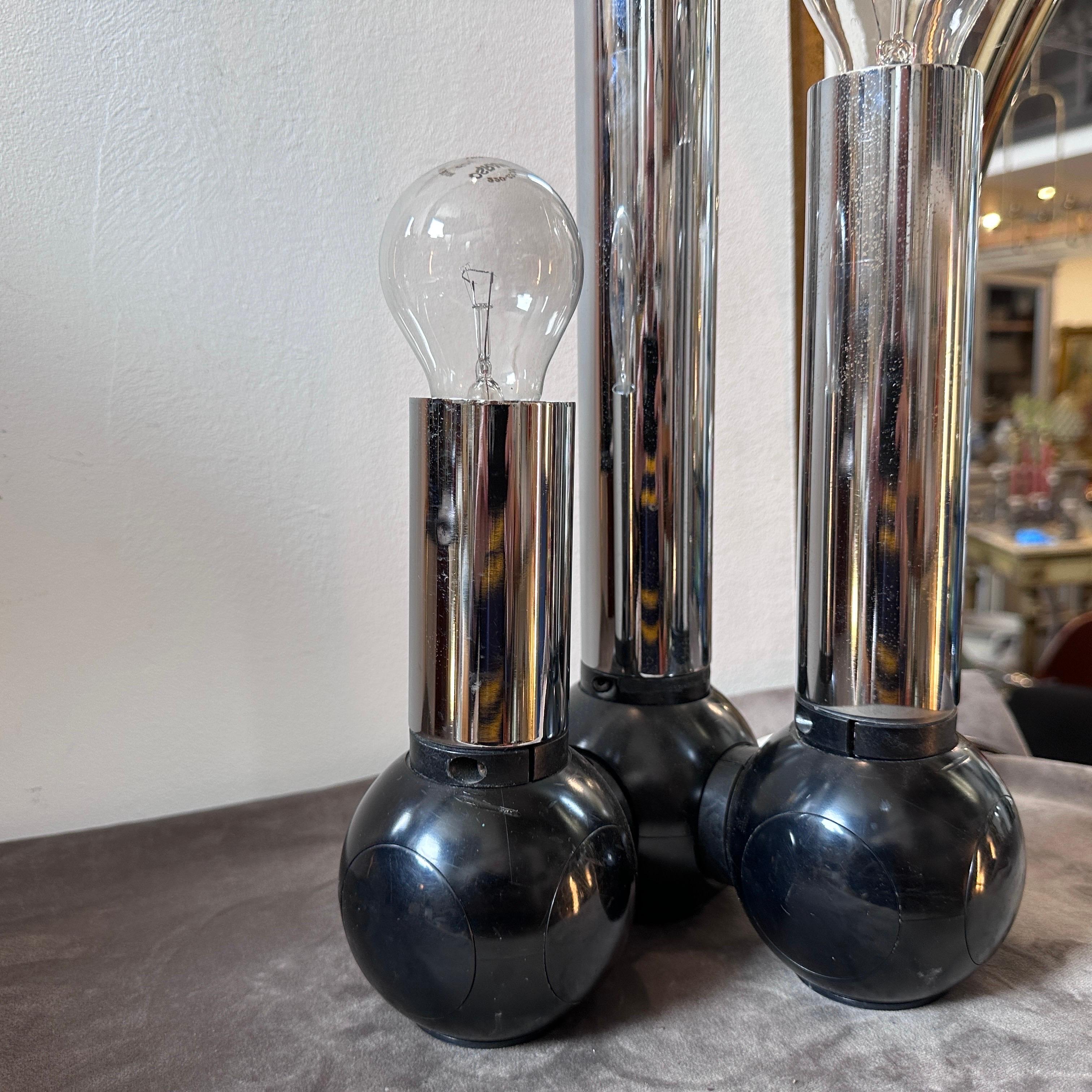 A three lights table lamp designed and manufactured in Italy by Targetti in the Seventies, chromed metal and black plastic lower parts are in good conditions, it's marked on the base.
The Table Lamp by Targetti Sankey is a striking and futuristic