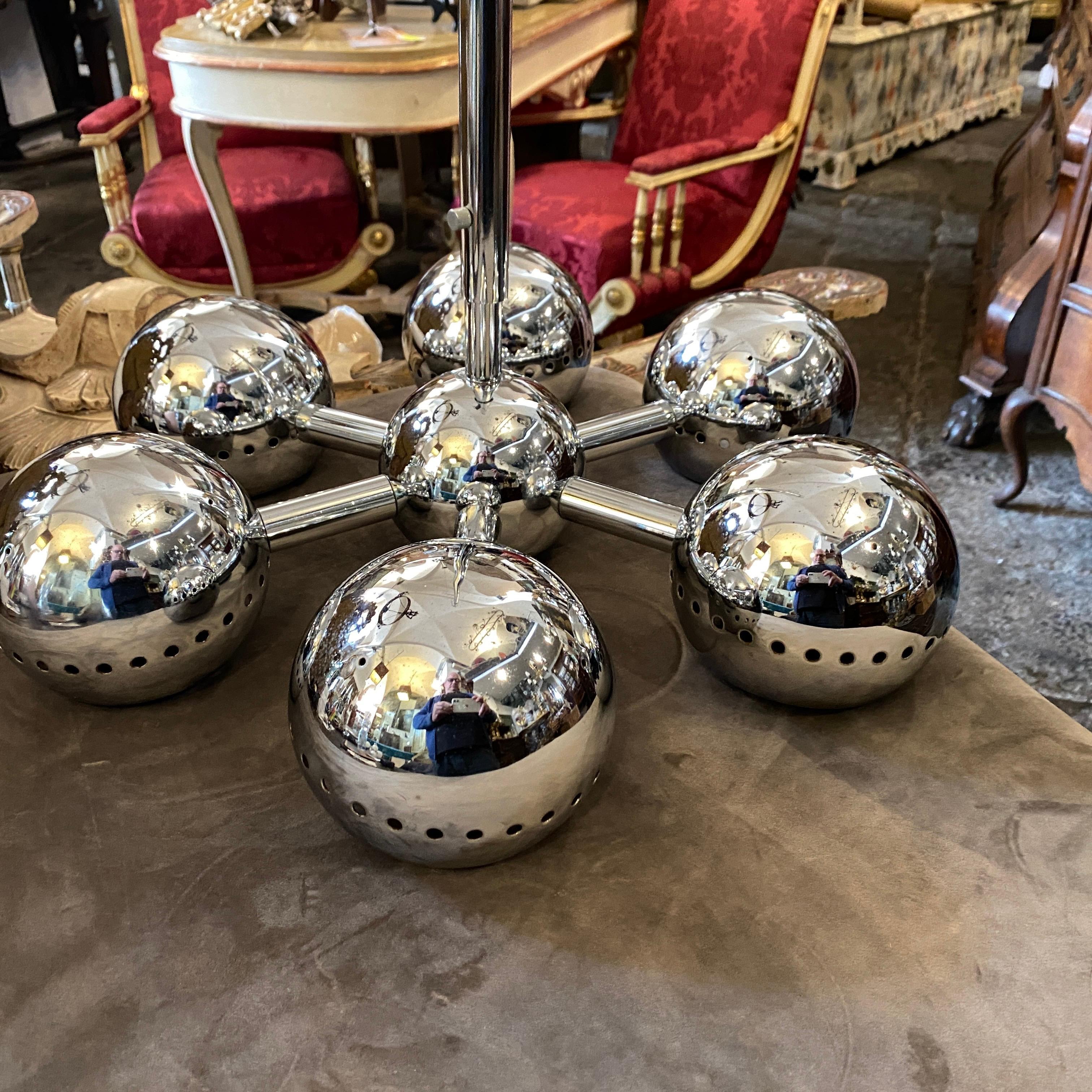 A midcentury chandelier made in Italy, chromed metal is in perfect conditions, the stem is extendable. It works 110-240 volts and needs regular bulbs.