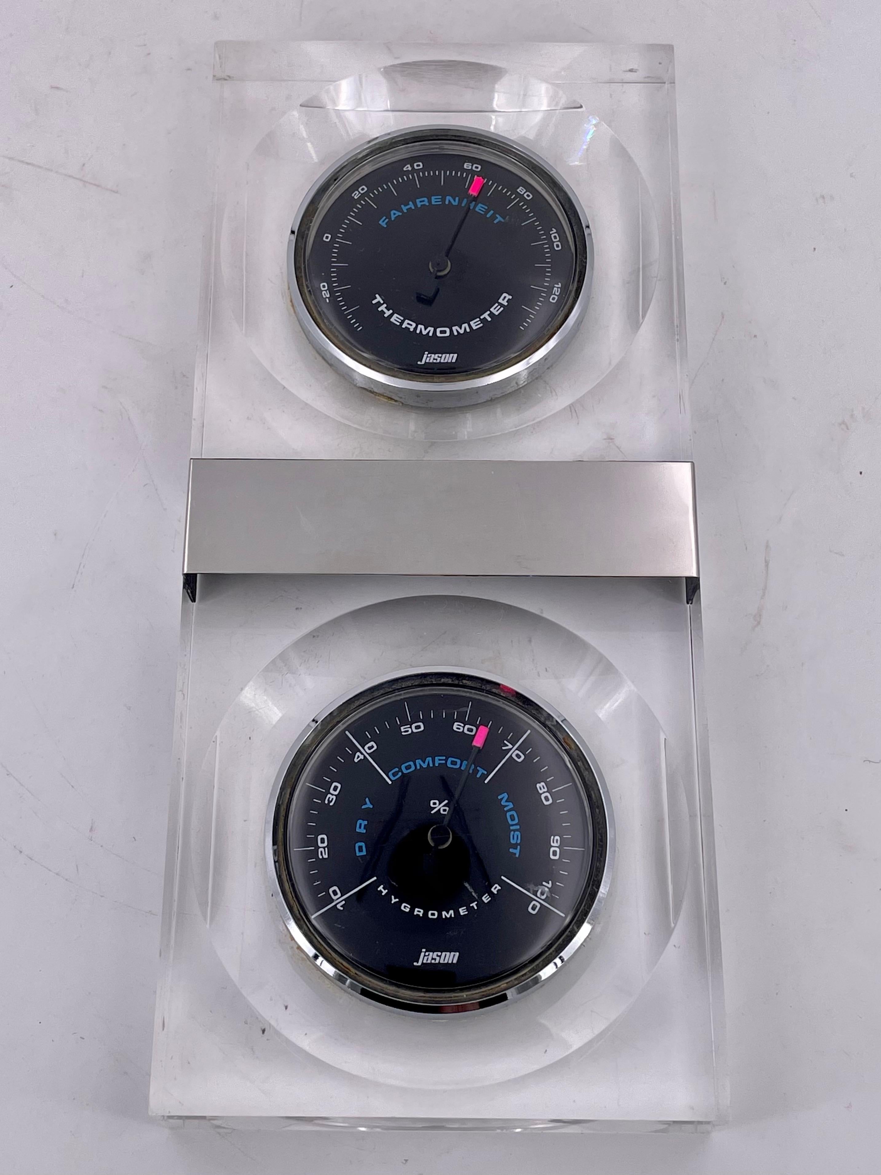 Space Age thermometer and hygrometer by Jason, great design in solid Lucite Space Age item rare made in the USA, it can be used as a wall hanging or tabletop.