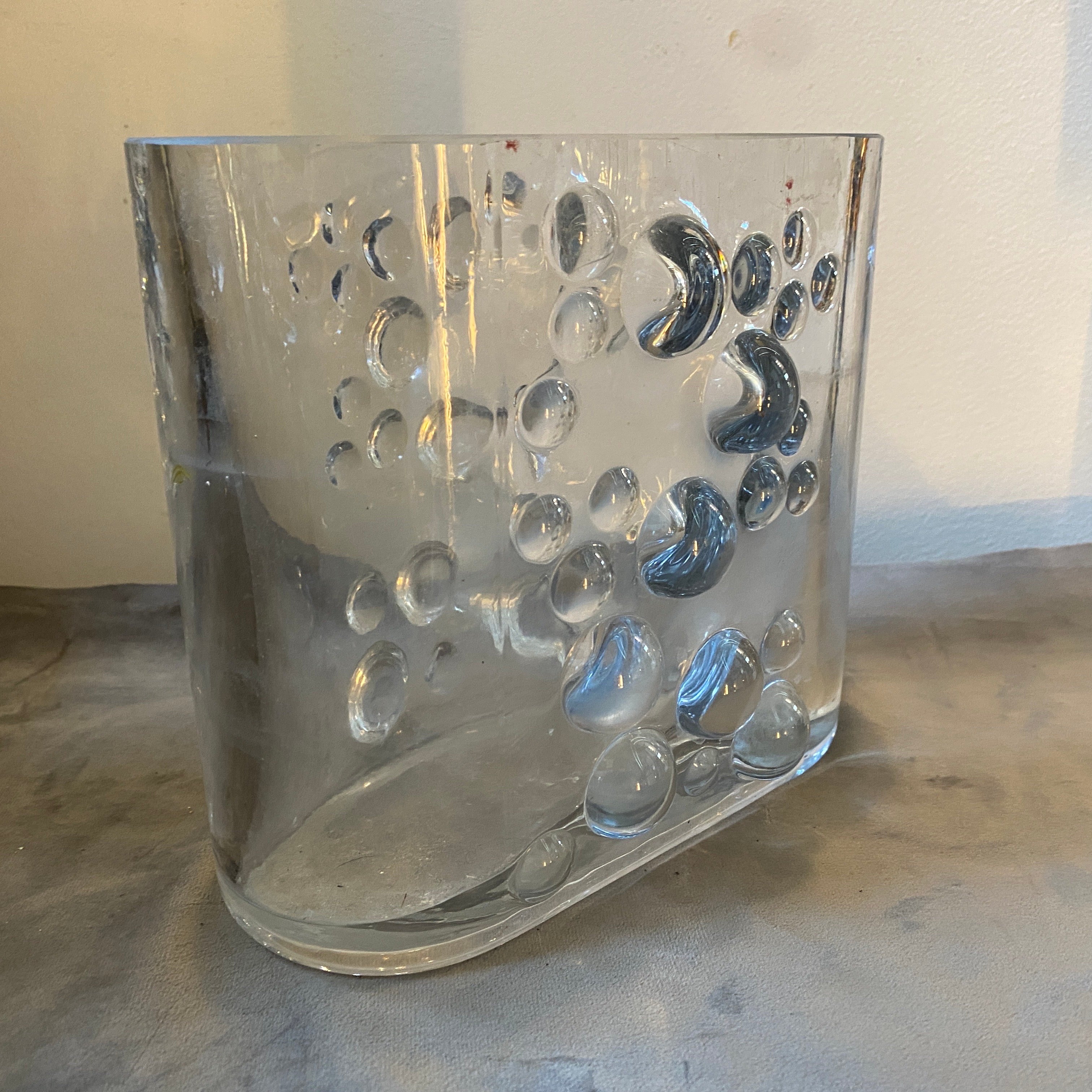 A space age oval heavy glass vase designed and manufactured in Italy in the Seventies in Empoli, small town in Tuscany famous for high quality crystal production. The vase it's in perfect conditions. This Italian Oval Bubble Vase is a captivating
