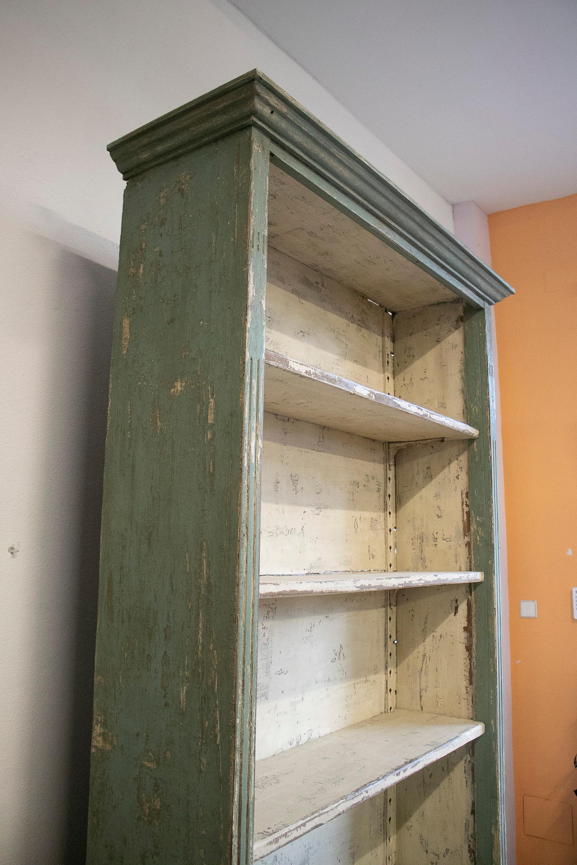 Vintage 1970s Spanish 4-shelf and 2-door painted wooden industrial bookshelf.