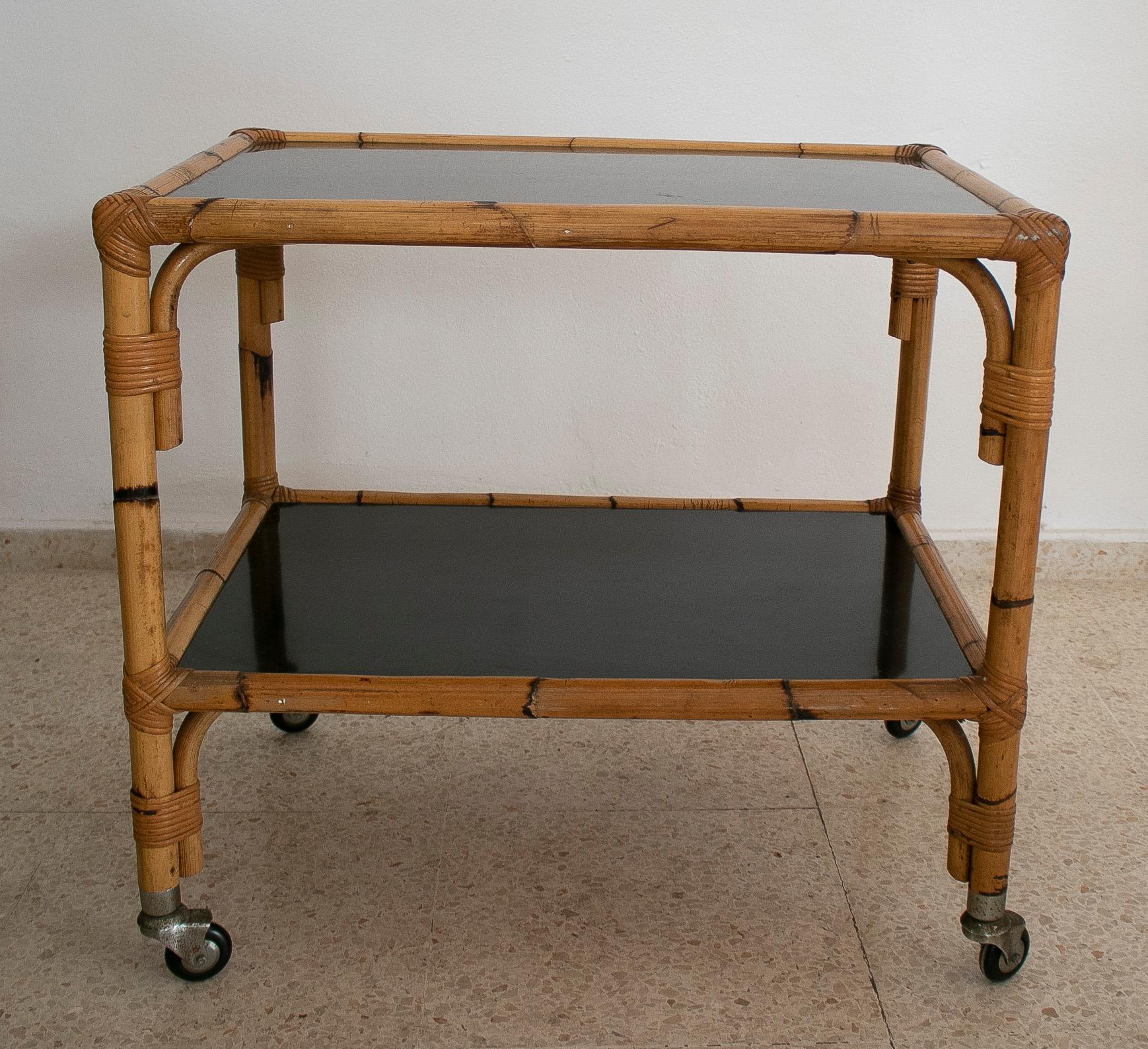 Vintage 1970s Spanish bamboo 2-shelves trolley with smoked glass panels.