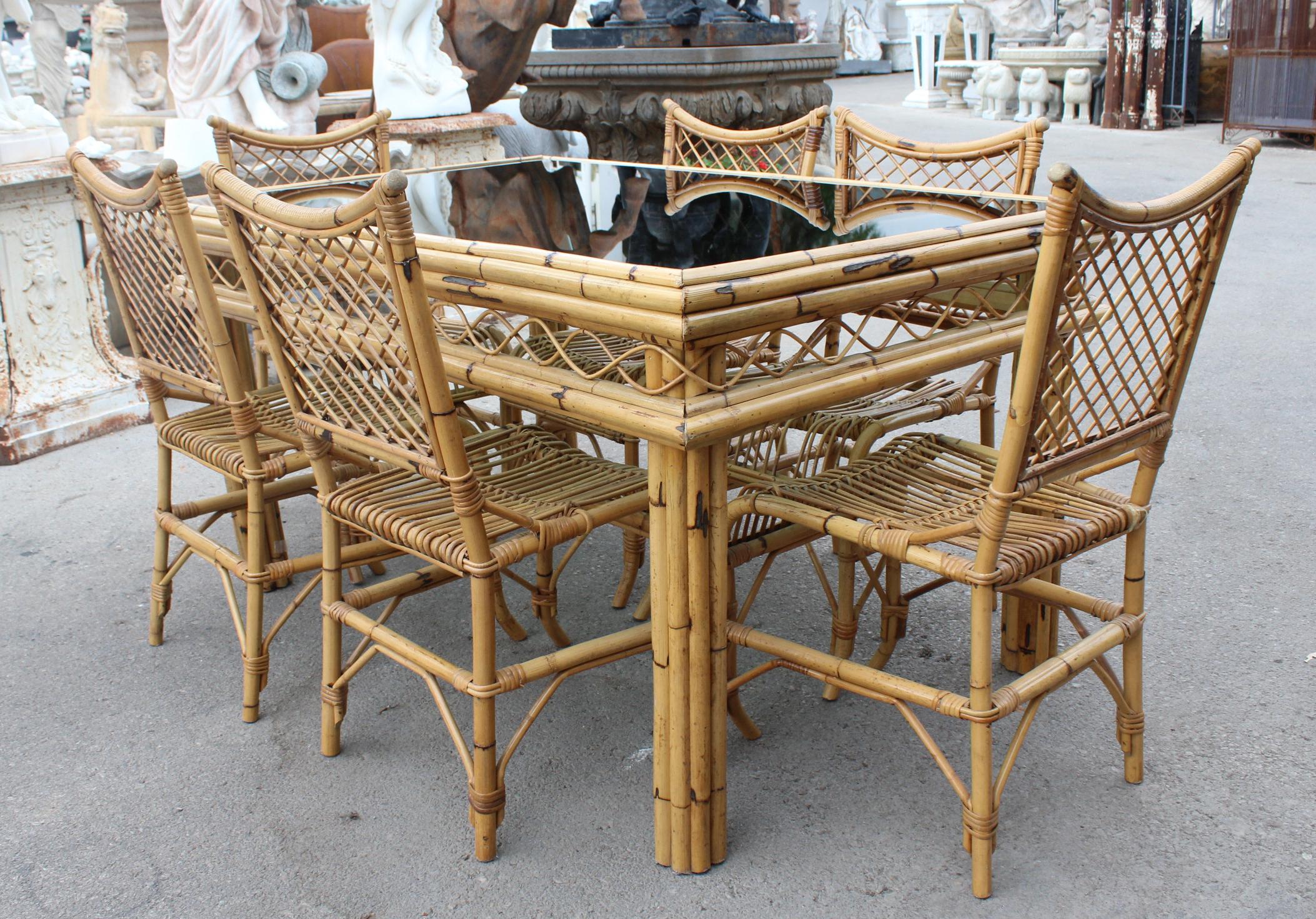 1970s Spanish bamboo and rattan 6-seat dining set with smoked glass top.

Table size: 82 x 144 x 97
Chair size: 95 x 44 x 55.