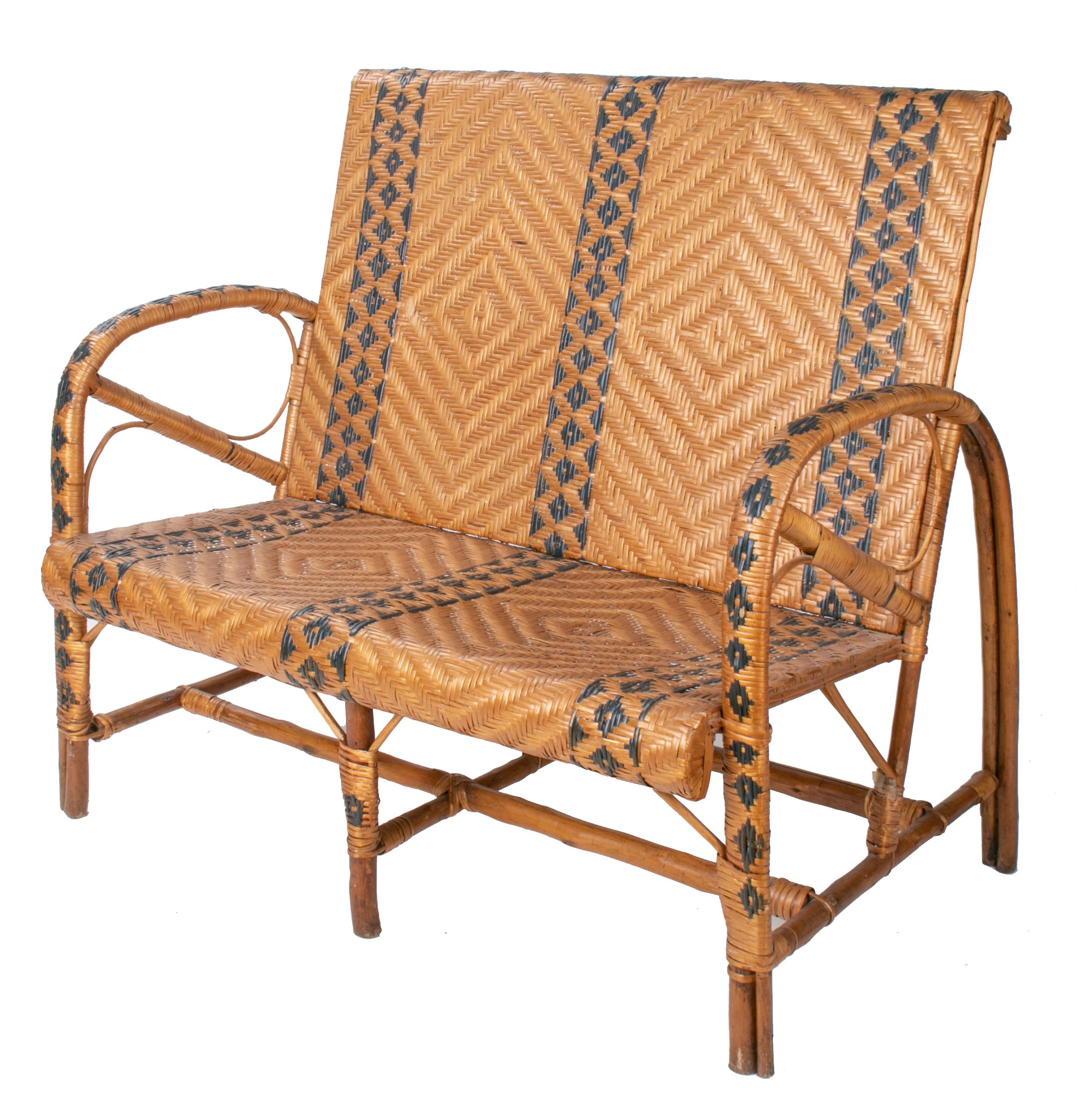 1970s Spanish bamboo and wicker two-tone set comprised of three armchairs, a sofa and a table. Geometric decoration that extends from top to the base of the legs.

Dimensions:
Armchairs 90 cm height, 52 cm length, 58 cm width
Table 67 cm height,