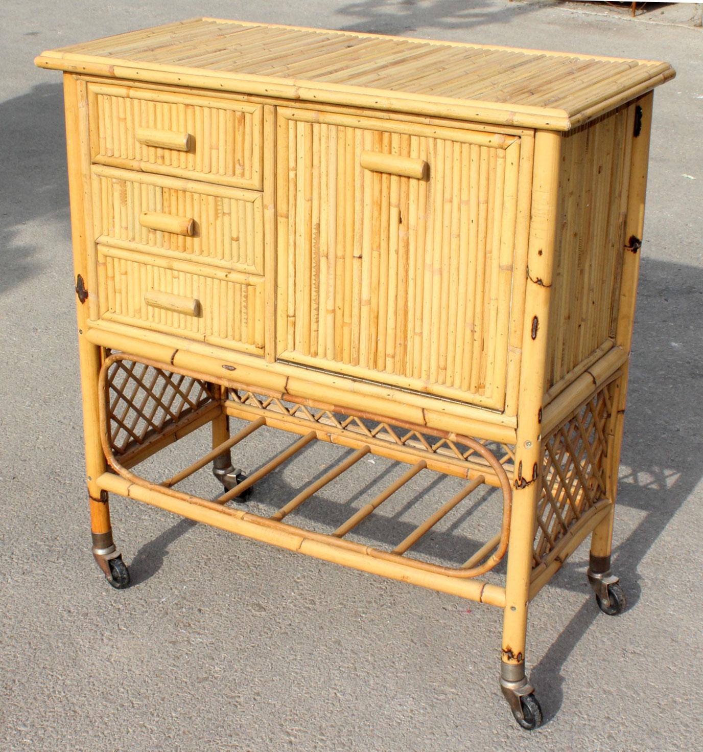 1970s Spanish bamboo bar cart trolley with three drawers, cabinet door and a bottom shelf.

