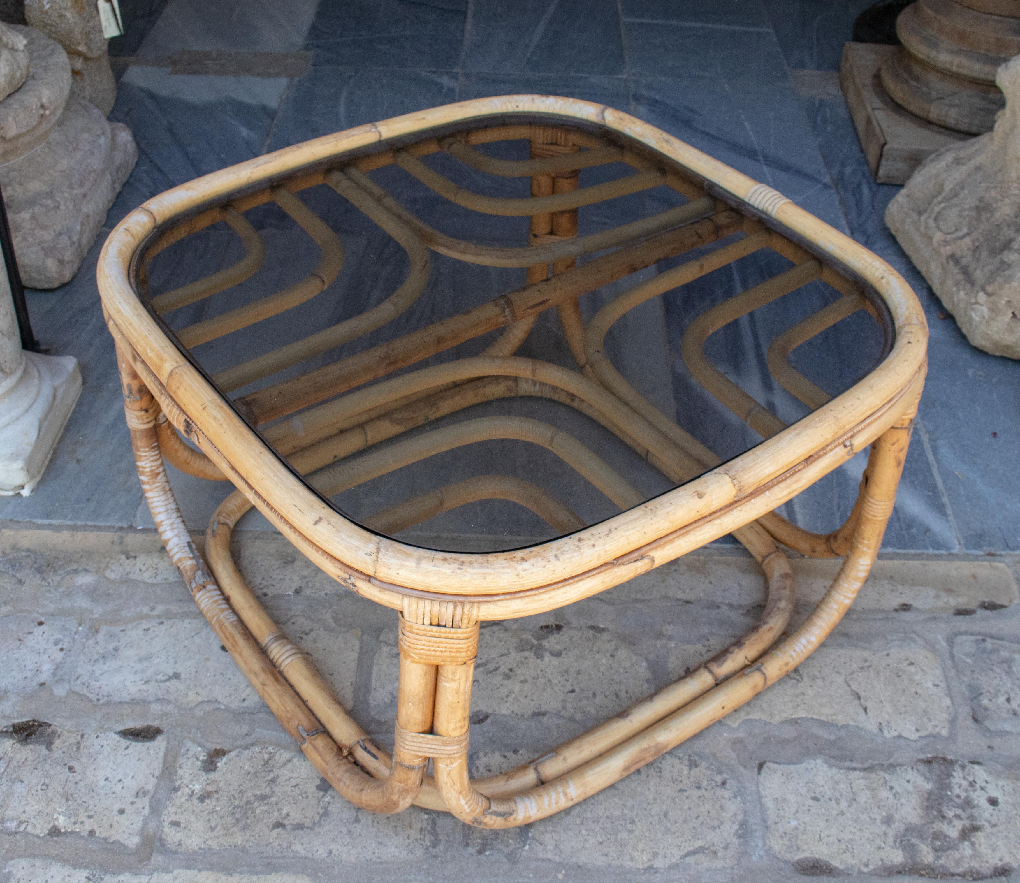 1970s Spanish bamboo coffee table with smoked glass top.