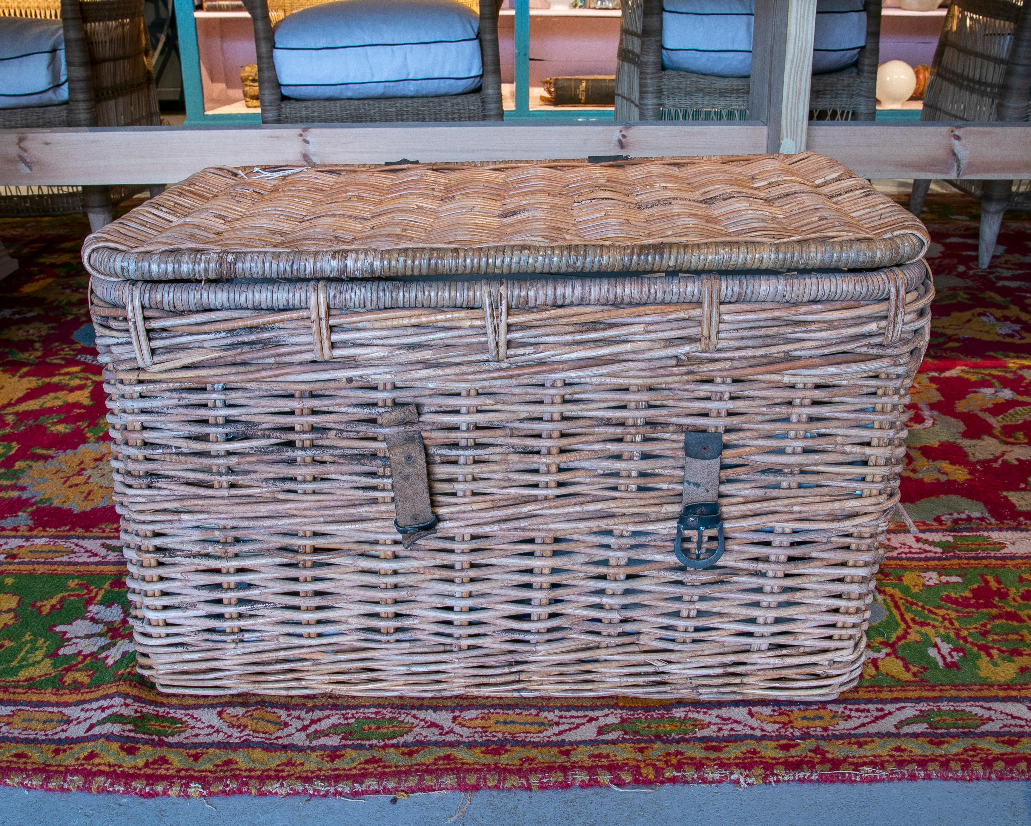 Rustic 1970s Spanish woven wicker farmhouse trunk with lid and leather straps. 

It has an interesting lime-washed feel.