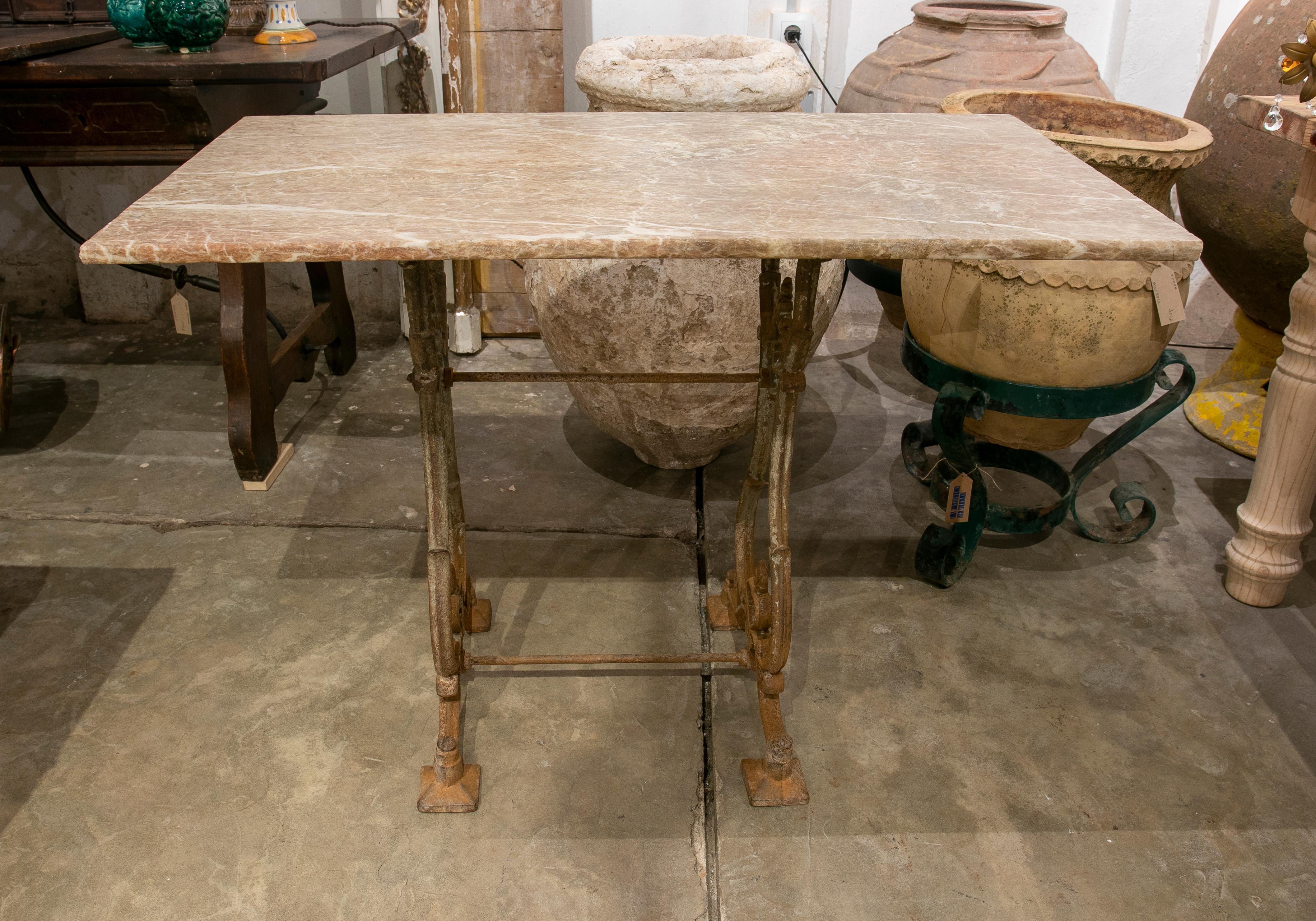 1970S Spanish garden table with iron base and marble top.