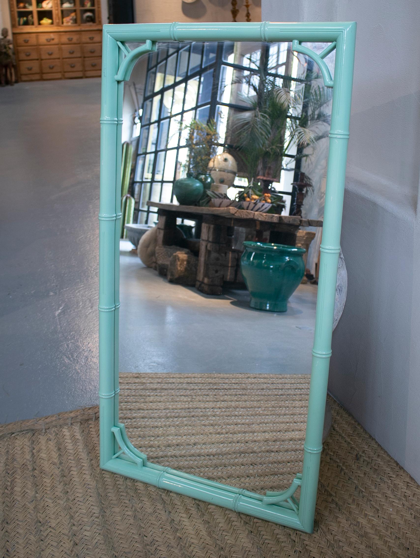 Vintage 1970s Spanish green lacquered faux bamboo mirror.