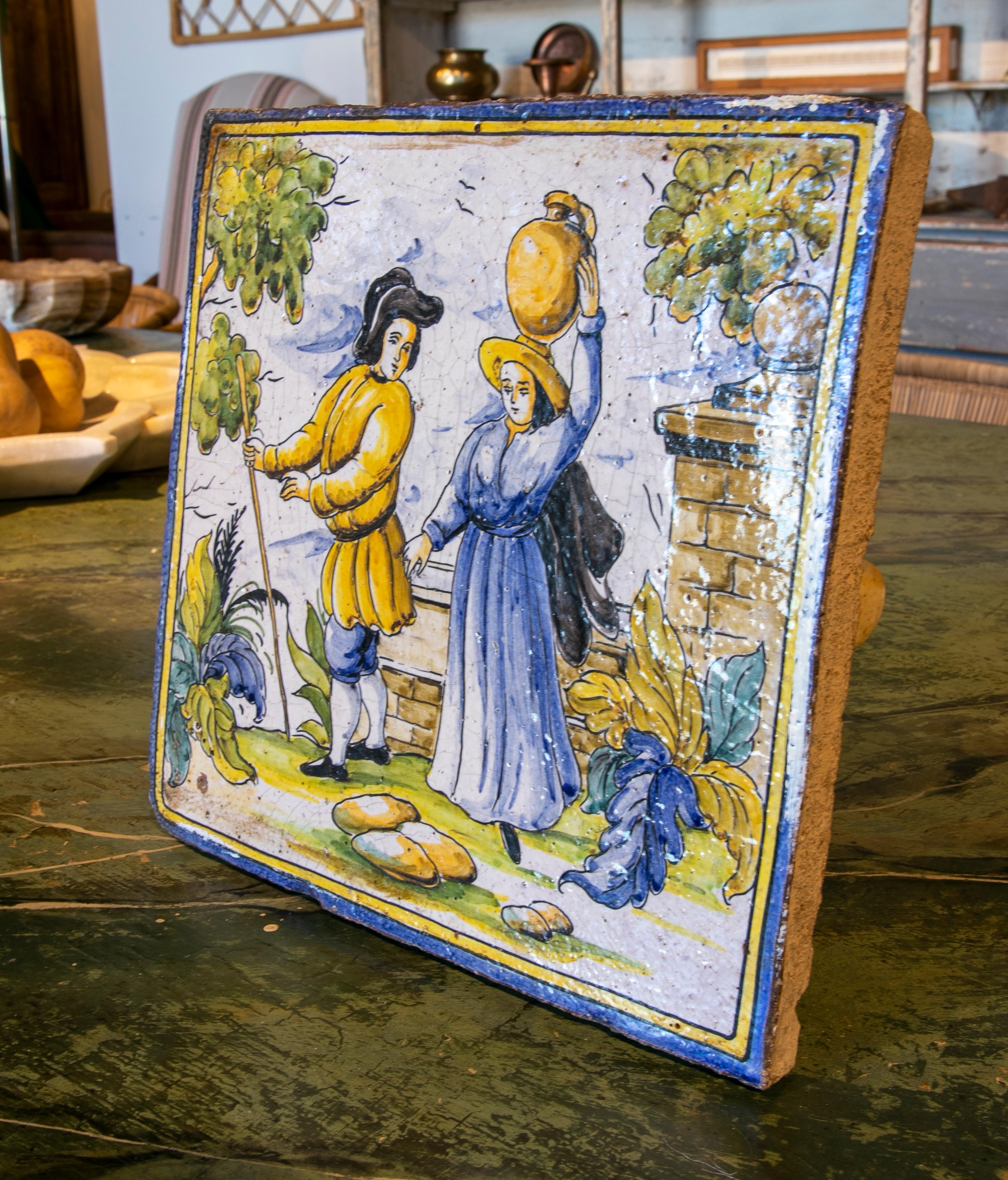 1970s Spanish hand painted glazed ceramic tile with people scene.