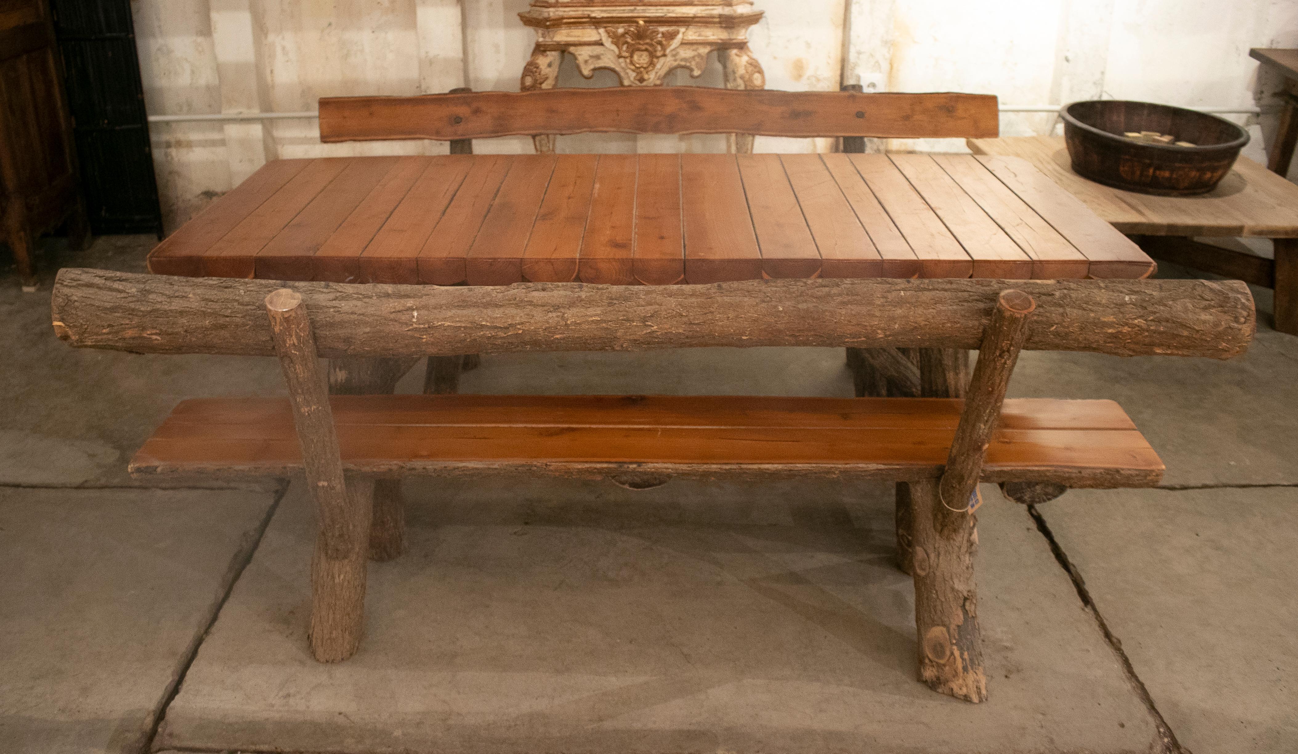 Rustic 1970s Spanish handmade garden wooden table with benches. 

Table dimensions: 77 x 202 x 85cm
Benches dimensions: 84 x 200 x 50cm.