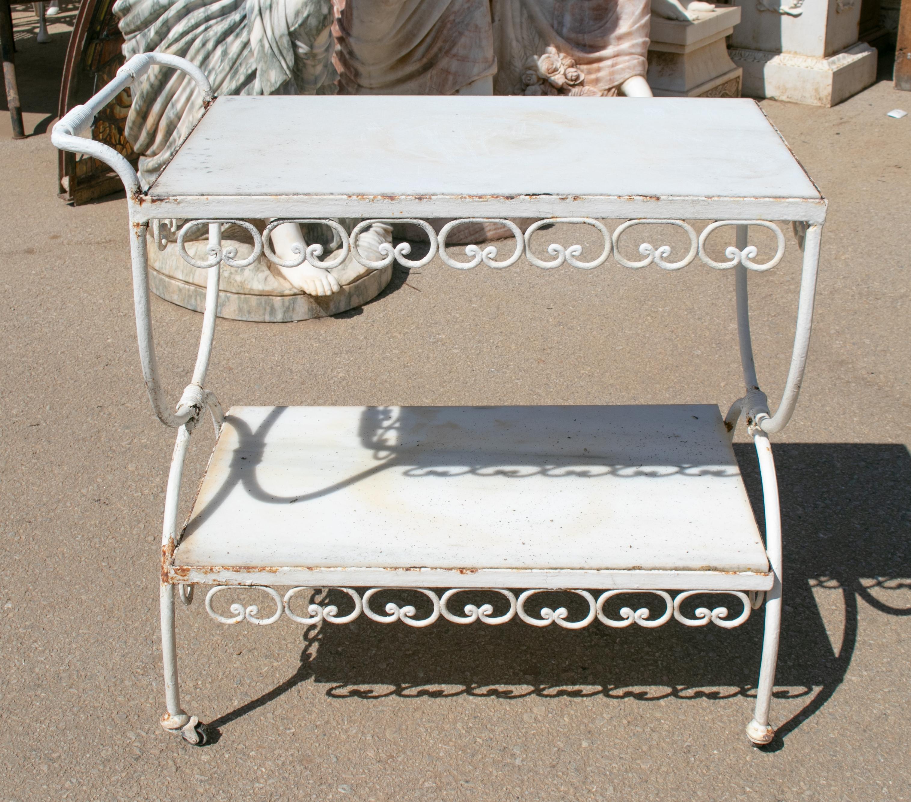 1970s Spanish iron drinks trolley with marble shelves.