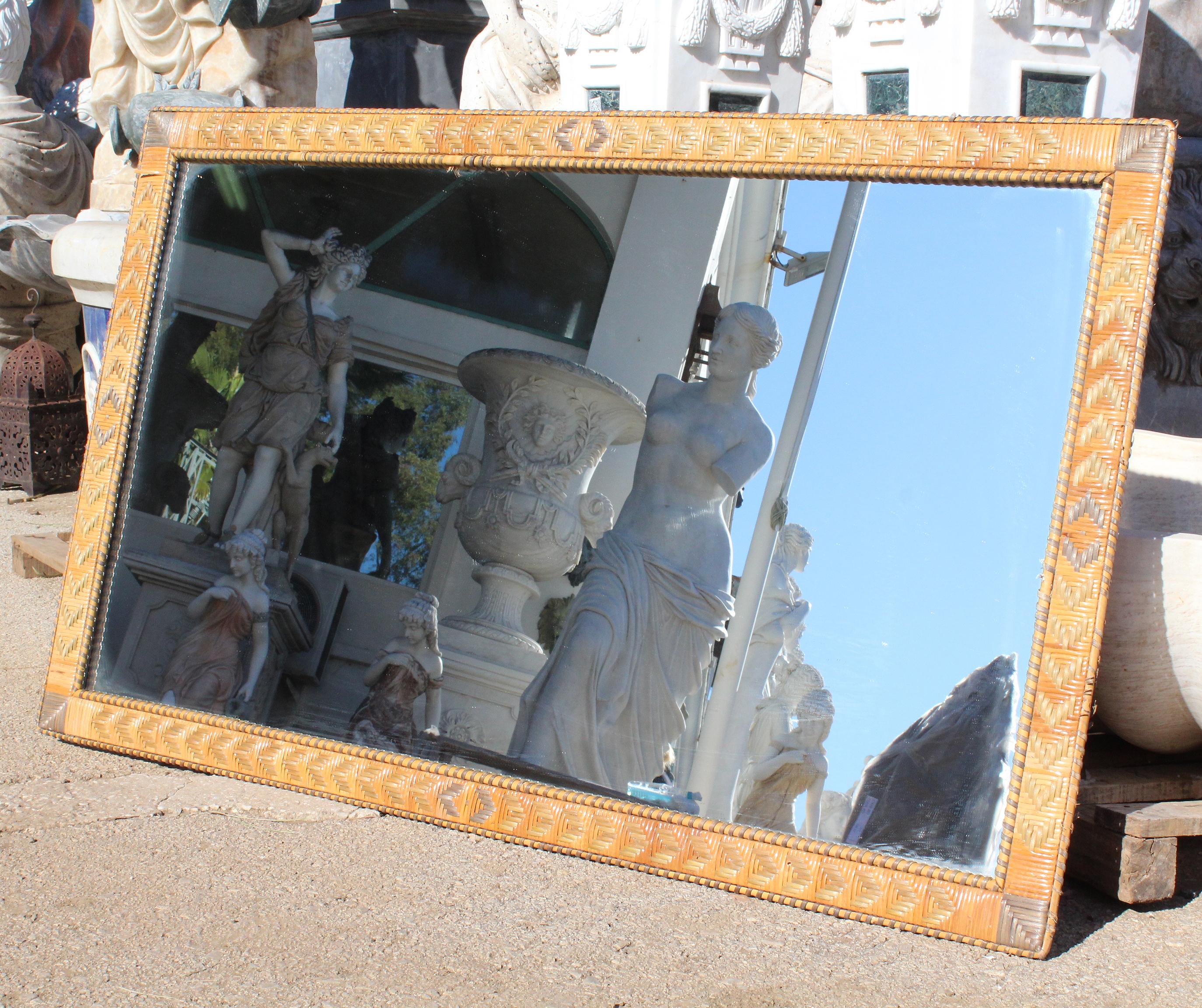 1970s Spanish rectangular framed mirror with patterns made with different colored lazed wicker.